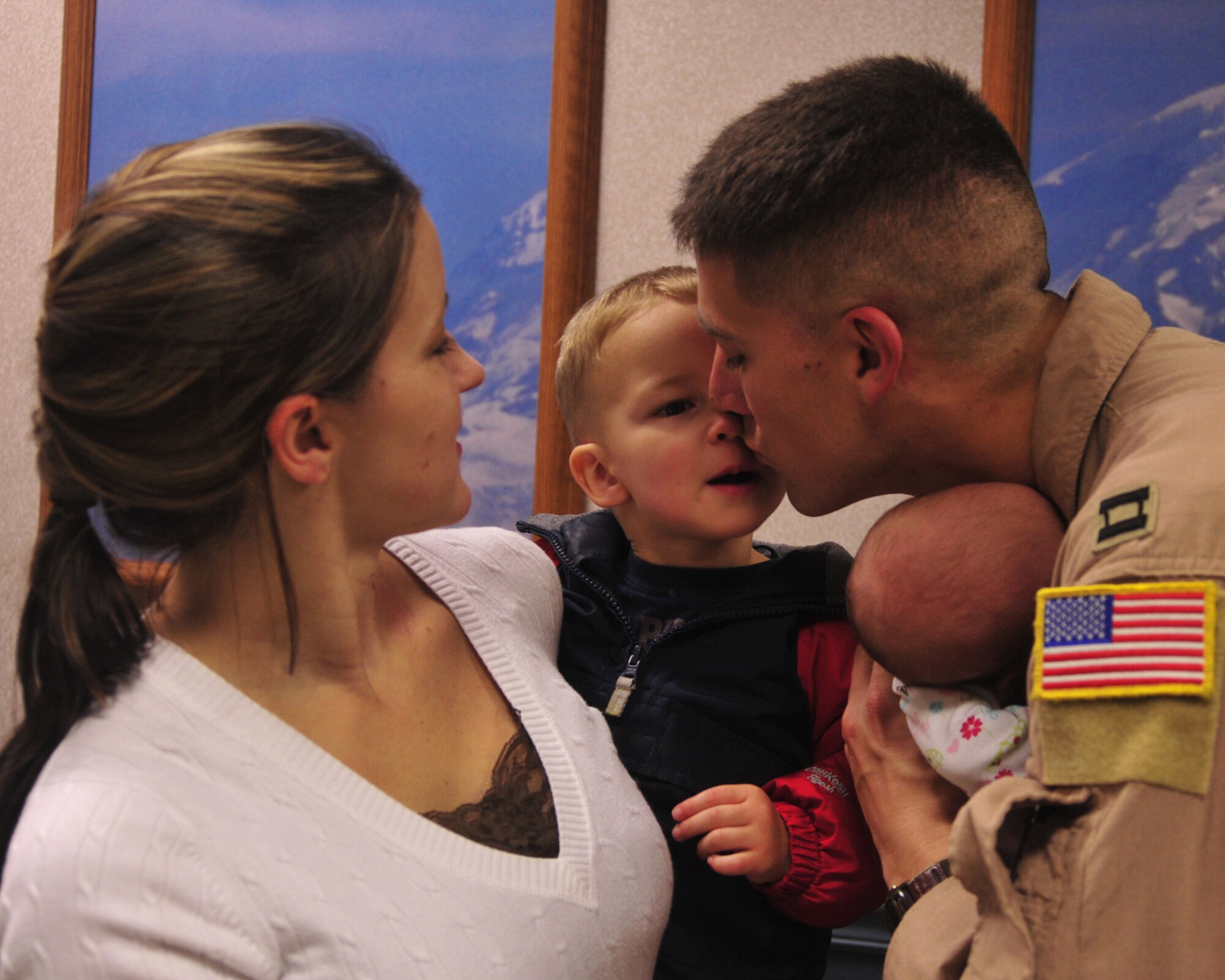 Capt. Kent Portue, 4th Airlift Squadron pilot, says good bye to his wife, Andrea, son, Kent III, and daughter, Makenzie, prior to leaving for a deployment Oct. 25, 2011, at Joint Base Lewis-McChord, Wash. The 4th AS deployed to the Middle East in support of Operations Enduring Freedom and New Dawn. (U.S. Air Force photo/Staff Sgt. Frances Kriss)