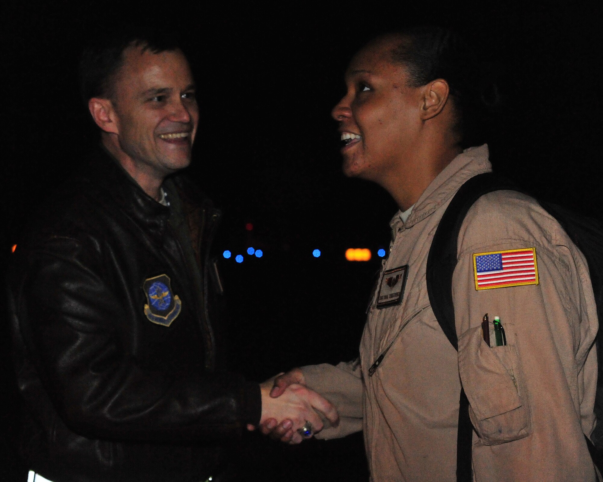 Lt. Col. Thomas O'Connell, 4th Airlift Squadron commander, shakes the hand of Staff Sgt. Orial Christopher, 62nd Operations Support Squadron, as she boards an aircraft for a deployment Oct. 25, 2011, at Joint Base Lewis-McChord, Wash. Christopher will be supporting the 4th AS during their 60-day deployment to the Middle East. (U.S. Air Force photo/Staff Sgt. Frances Kriss)
