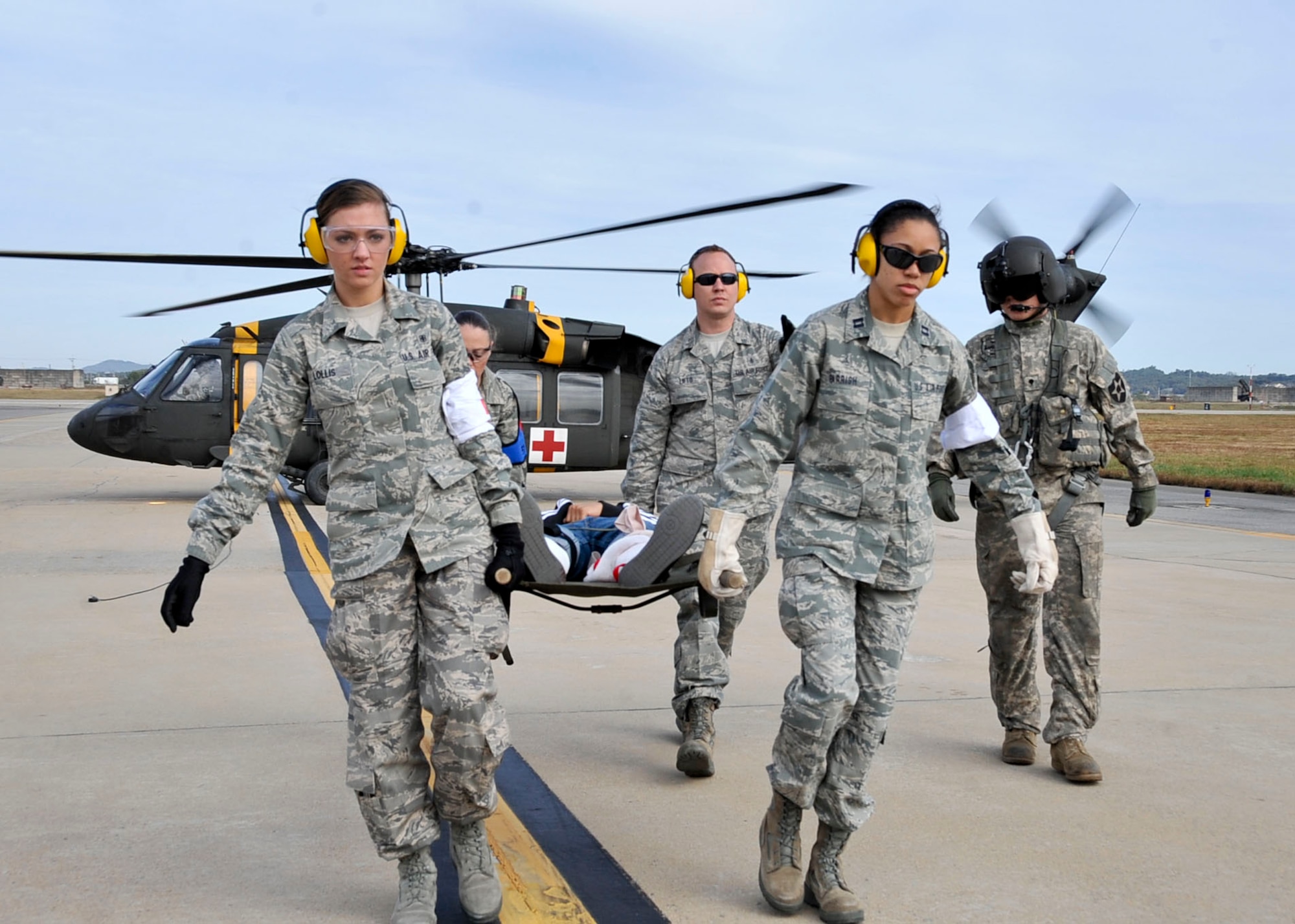 Members from the 51st Aerospace Medicine Squadron field response team unload a casualty during the Emergency Management Exercise Oct. 21, 2011. Osan responders reacted to a scenario of: a simulated CH-47 that collided with a C-130 static display during the air show resulting in the death of six and 34 (U.S. Air Force photo/Senior Airman Adam Grant)