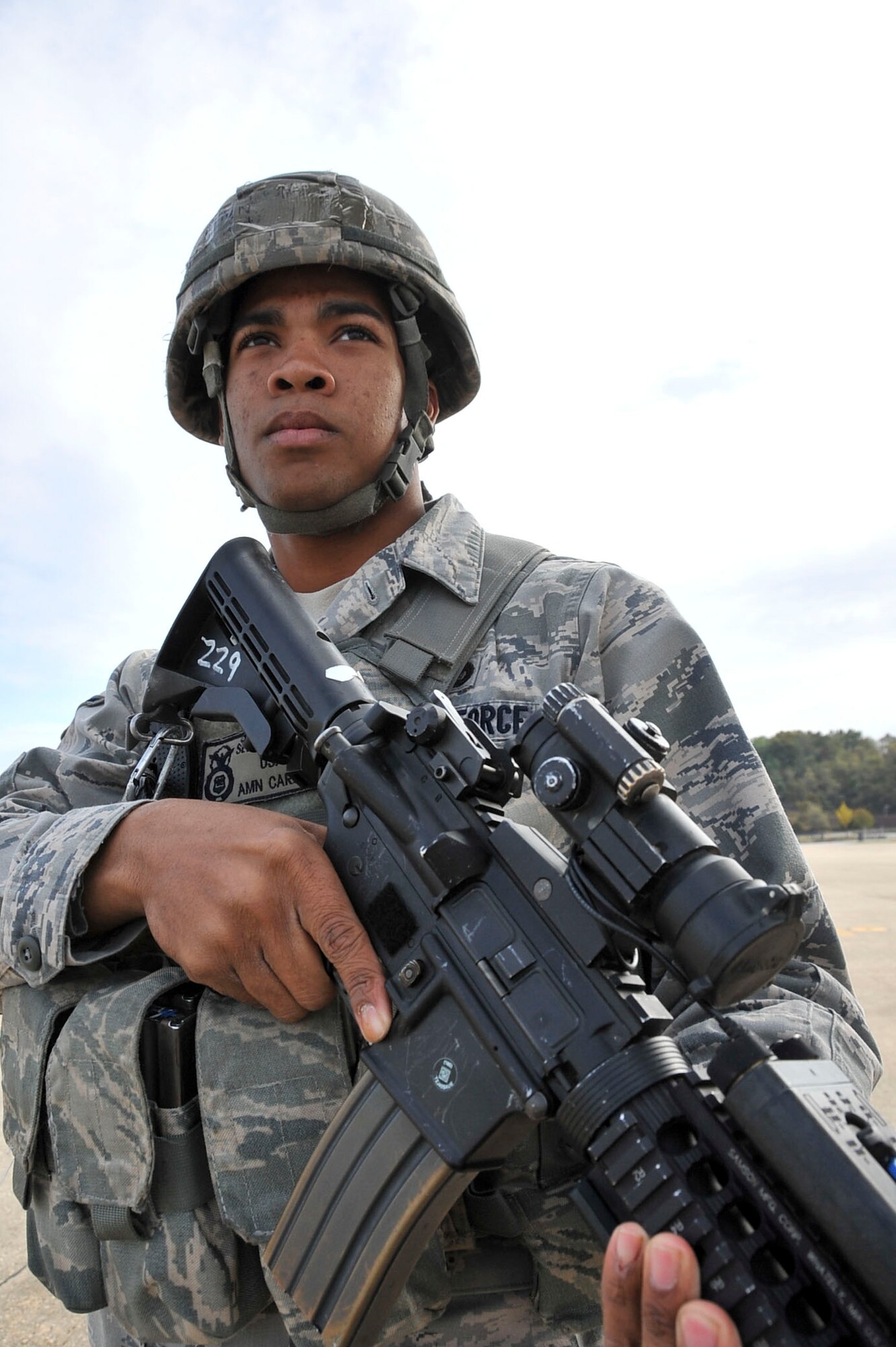 Airman Hosea Carson, 51st Security Forces Squadron entry controller, provides security during the Emergency Management Exercise Oct. 21, 2011.  During the exercise members of the 51st SFS maintained control over the cordons while ensuring that all unauthorized personnel detected, were detained and escorted out of the area AOR.  (U.S. Air Force photo/Senior Airman Adam Grant)