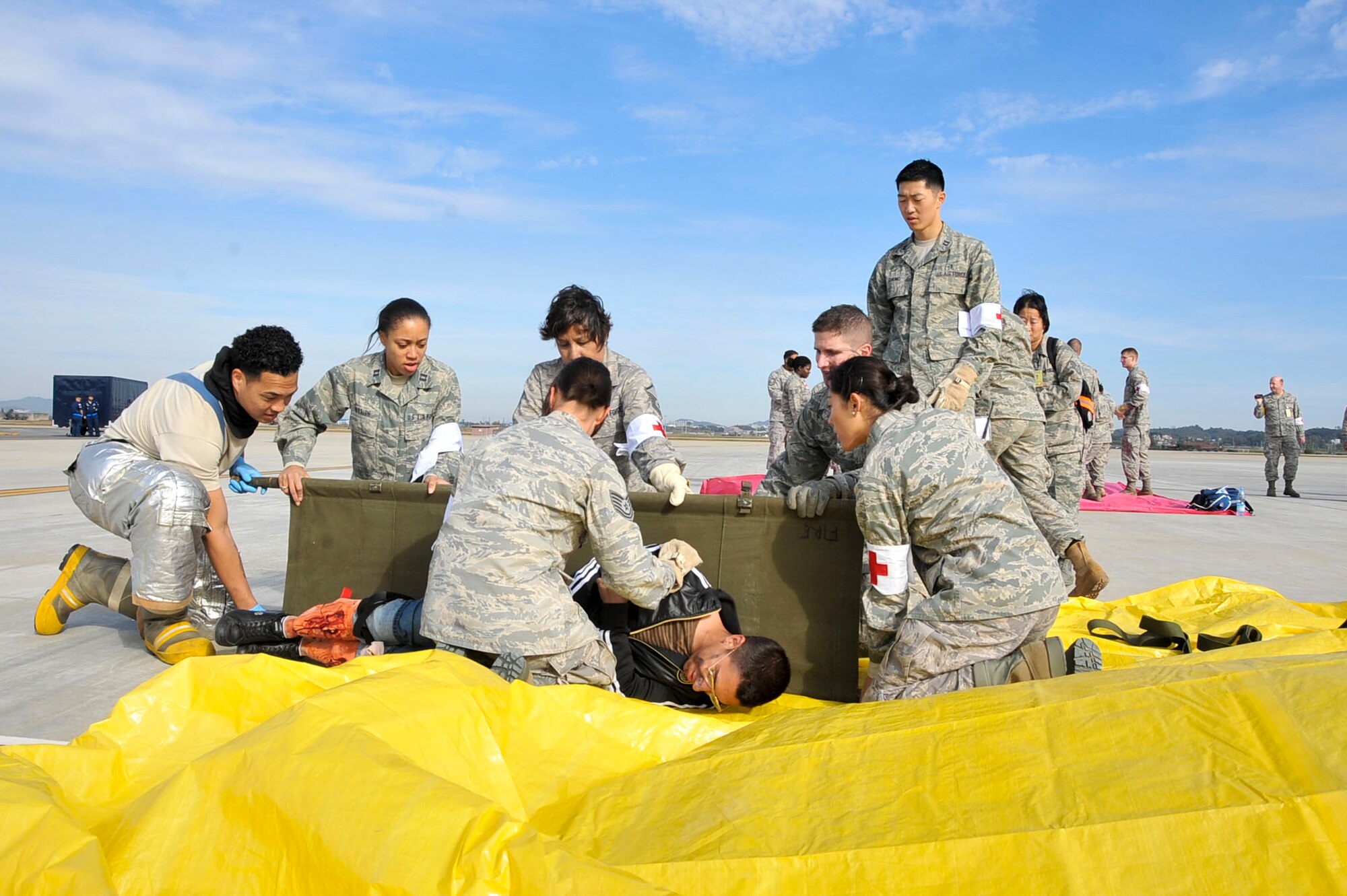Members from team Osan prepare to load a casualty during the response phase of the Emergency Management Exercise Oct. 21, 2011.  The EME tested the preparedness of Osan responders as they were evaluated on four major areas which are notification, response, withdrawal and recovery. (U.S. Air Force photo/Senior Airman Adam Grant)