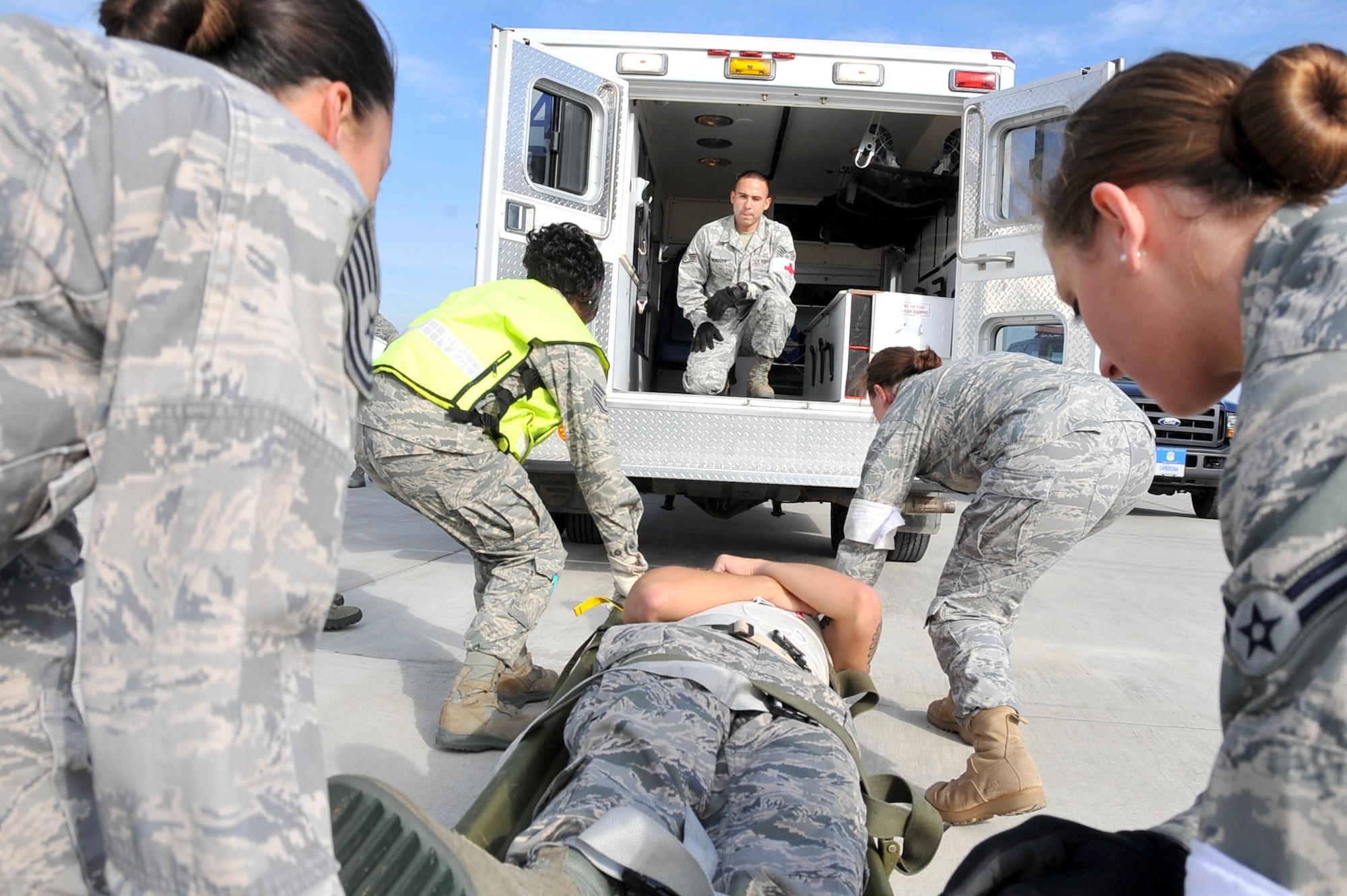 Members from the 51st Aerospace Medicine Squadron field response team prepare to load a casualty during the Emergency Management Exercise Oct. 21, 2011. Osan responders reacted to a scenario of: a simulated CH-47 that collided with a C-130 static display during the air show resulting in the death of six and 34 (U.S. Air Force photo/Senior Airman Adam Grant)