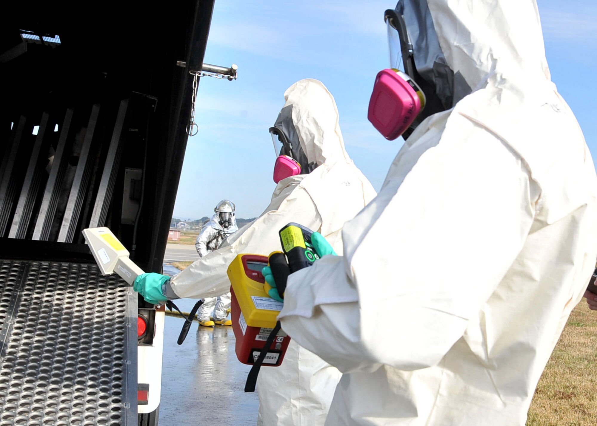 Members of the 51st Aerospace Medical Squadron bioenvironmental fight, scan the scene of a simulated crash during an Emergency Management Exercise Oct. 21, 2011. The purpose of the EME was to test the preparedness of Osan responders. (U.S. Air Force photo/Senior Airman Adam Grant)