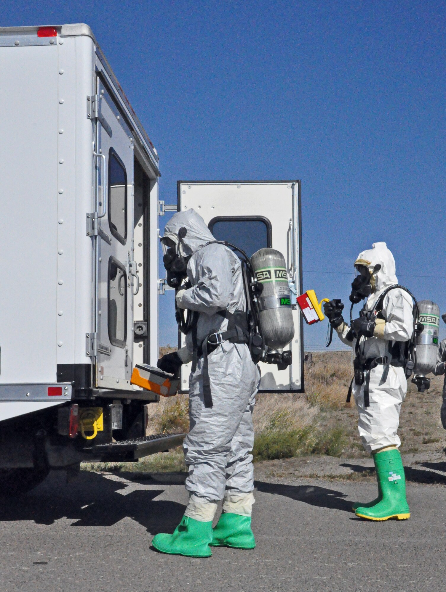 Staff Sgt. Joe Neejer, 60th Civil Engineer Squadron emergency management, and Staff Sgt. Ronald Cruz, 60th Medical Group bioenvironmental work together to locate the source of a radiology truck Oct. 20 during a task force exercise.