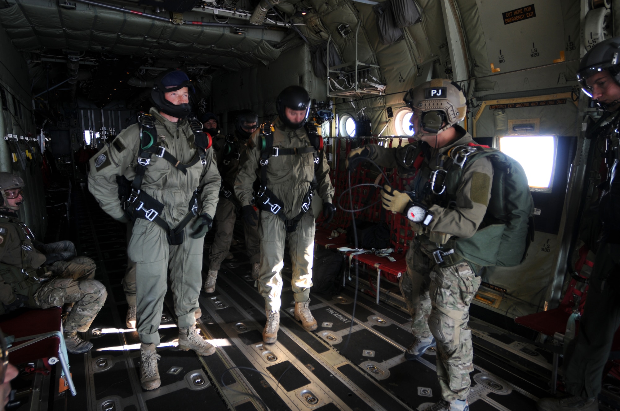 WESTERN EUROPE – Pararescuemen from 56th Rescue Squadron and European Air Group forces prepare to jump from a C-130J Hercules during an exercise, Oct. 26, 2011. The scenario was a search and rescue mission in which the goal was for the pararescue team to recover two military personnel who were involved in a plane crash and ended with European Air Group personnel extracting the pararescue team and their patients. (U.S. Air Force photo by Airman Cory D. Payne)