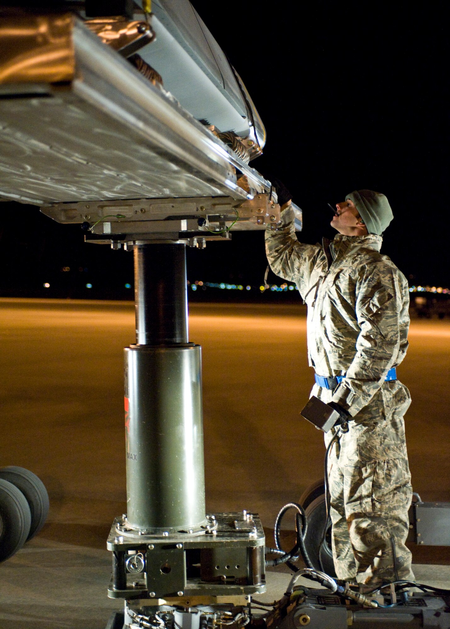 Staff Sgt. John Quiggle, 28th Aircraft Maintenance Squadron weapons load team chief, ensures that the Joint Air-to-Surface Standoff Missile is secure on an MHU-83D bomb lift truck before being loaded into the B-1B Lancer on Ellsworth Air Force Base, S.D., Oct. 24, 2011. A JASSM is a 2,000-pound conventional, precision, launch-and-leave standoff munition that can be launched from bombers or fighters. (U.S. Air Force photo by Airman Alystria Maurer/Released)