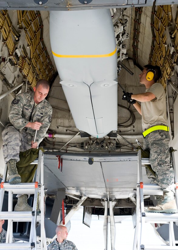 Tech. Sgt. Taft Tubbs, 28th Aircraft Maintenance Squadron weapons team chief, and Staff Sgt. Ryan Wooley, 28th AMXS weapons load crew member, lock a  Joint Air-to-Surface Standoff Missile into a B-1B Lancer's bomb bay on Ellsworth Air Force Base, S.D., Oct. 24, 2011. Aircrews from the 37th Bomb Squadron at Ellsworth employed the JASSM Oct. 25, 2011 during a Weapon System Evaluation Program exercise known as Combat Hammer. (U.S. Air Force photo by Airman Alystria Maurer/Released)
