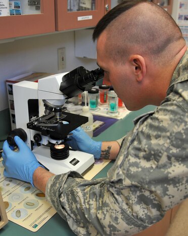 U.S. Army Pfc. Erik Bigham, veterinary assistant for 9th Force Support Squadron, Vet Command Beale Branch, examines an animal sample to check for parasites at the Veterinary Clinic on Beale Air Force Base, Calif., Oct. 21, 2011. The Veterinary Clinic on base offers routine checkups along with other medical services to a variety of animals. (U.S. Air Force photo by Airman 1st Class Rebeccah Anderson)
