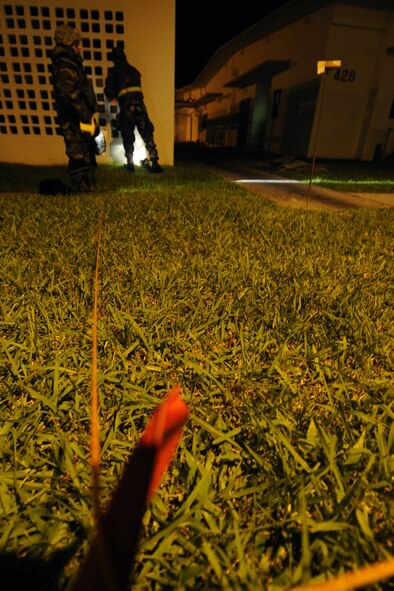 Staff Sgt. Cody Hester and Airman 1st Class Stephanie Fuller, 18th Aerospace Medicine Squadron Bio Environmental Engineering technicians, cordon off an area around a mock unexploded ordnance they found after performing a PAR sweep, or post attack reconnaissance sweep, during Beverly High 12-1, a local operational readiness exercise at Kadena Air Base, Japan, Oct. 27. The exercise tested the Wing's ability to deploy and receive forces as well as generate sorties. (US Air Force photo/Senior Airman Sara Csurilla)