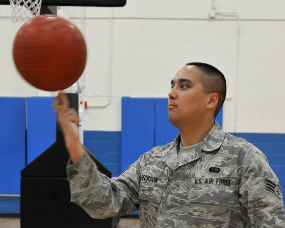 Senior Airman Alfred Peckson, 9th Force Support Squadron, shows off his basketball skills while working at the Harris Fitness Center on Beale Air Force Base, Calif., October 18, 2011. Airman Peckson is a fitness specialist and assists gym members with health and wellness; the 9th FSS is a 2010 Eubank Award winner. (U.S. Air Force photo by Airman 1st Class Rebeccah Anderson)