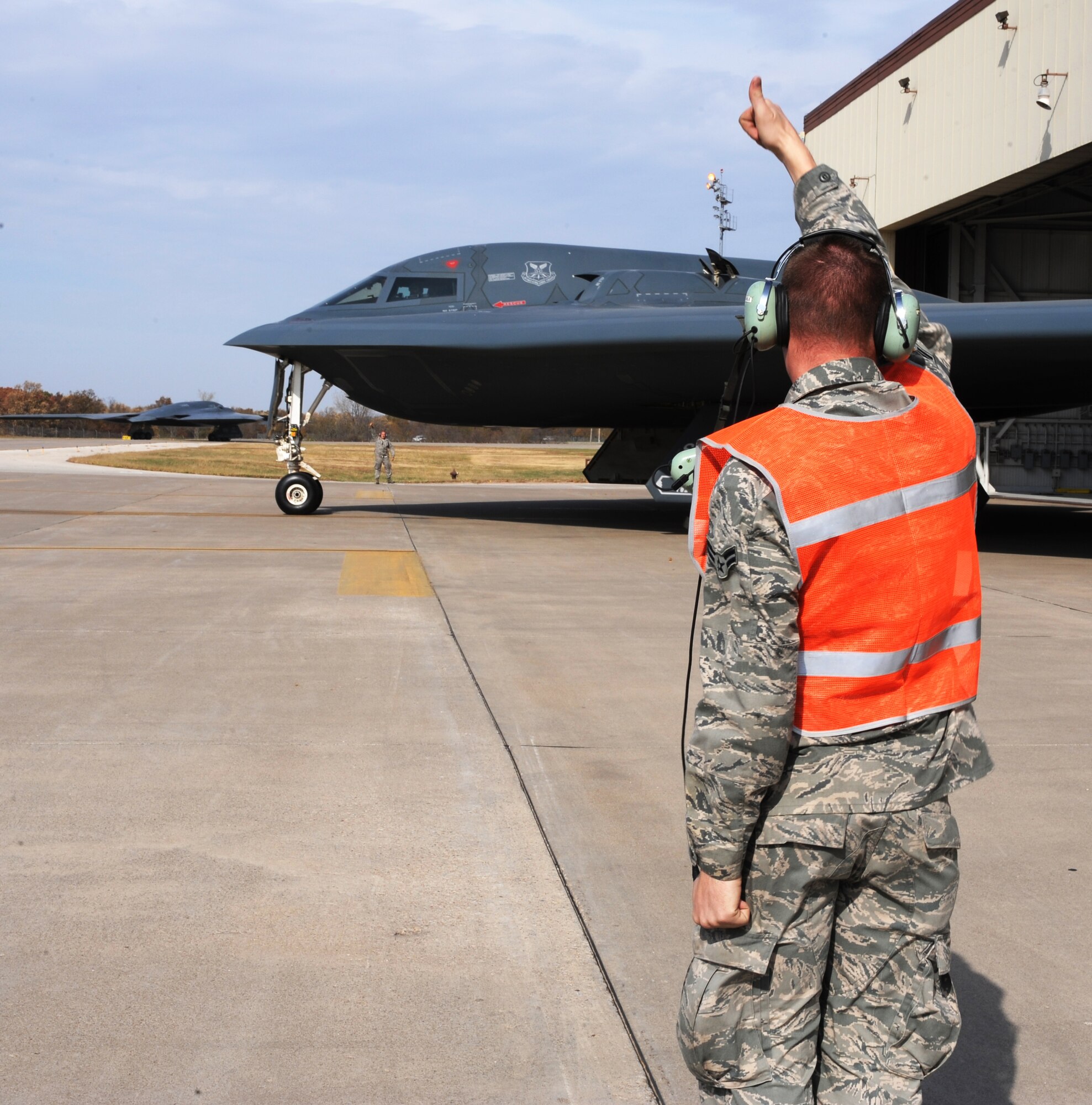 WHITEMAN AIR FORCE BASE, Mo -- Airman 1st Class Charles Price gives a thumbs up to a taxing B-2 Stealth Bomber during Global Thunder 12 Oct. 25. The exercise provides unique training opportunities for component, task force, unit forces, and command posts to deter, and if necessary defeat a military attack against the United States and to employ forces as directed by the president. Airman Price is a crew chief assigned to the 509th Aircraft Maintenance Squadron. (U.S. Air Force photo/Senior Airman Laura Goodgame) 