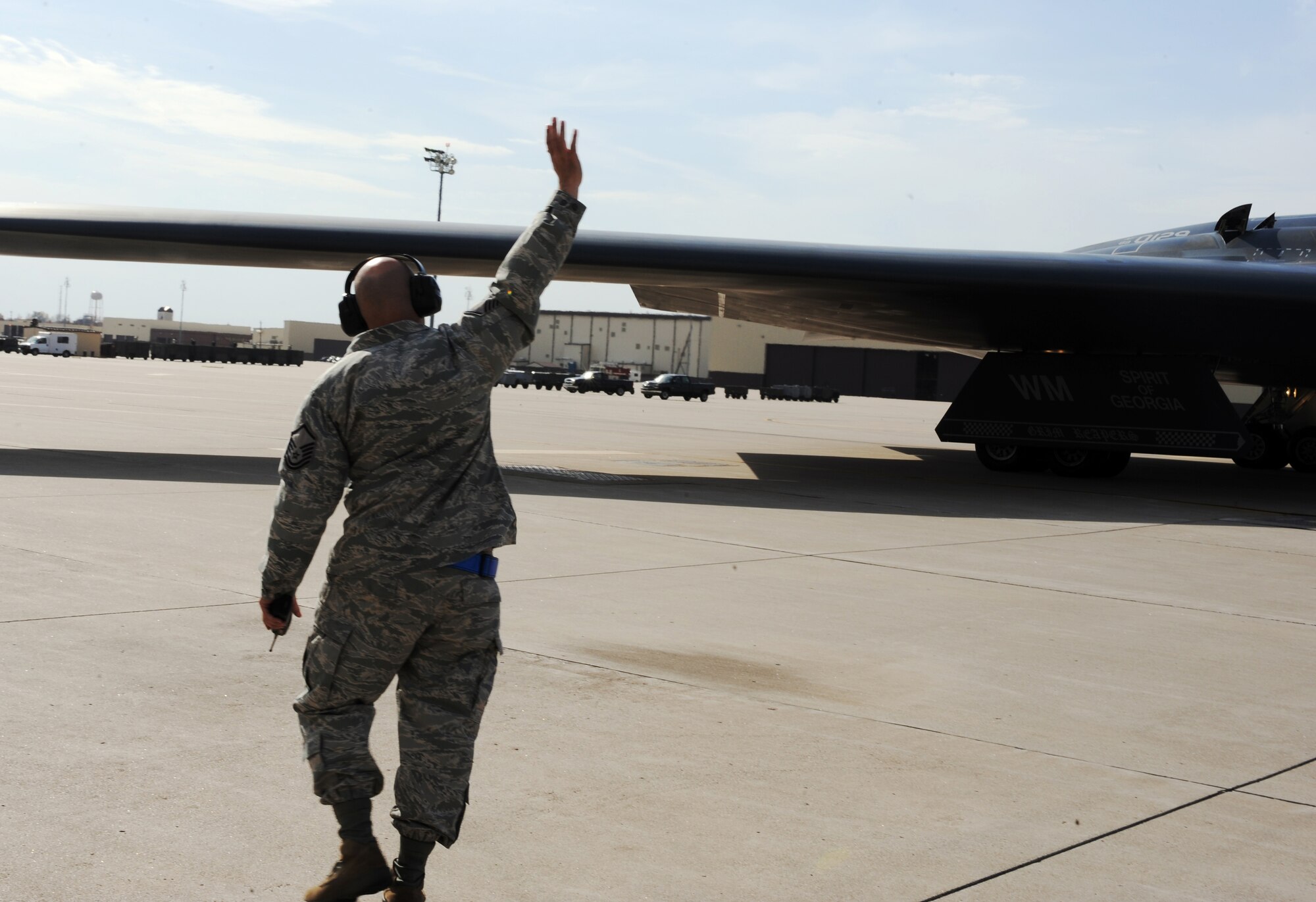 WHITEMAN AIR FORCE BASE, Mo -- Master Sgt. Stewart Reiter waves to a passing B-2 Stealth Bomber during Global Thunder 12 exercise Oct. 25. The exercise provides unique training opportunities for component, task force, unit forces, and command posts to deter, and if necessary defeat a military attack against the United States and to employ forces as directed by the president. Sergeant Reiter is assigned to the 509th Aircraft Maintenance Squadron and is a specialist section supervisor. (U.S. Air Force photo/Senior Airman Laura Goodgame) 