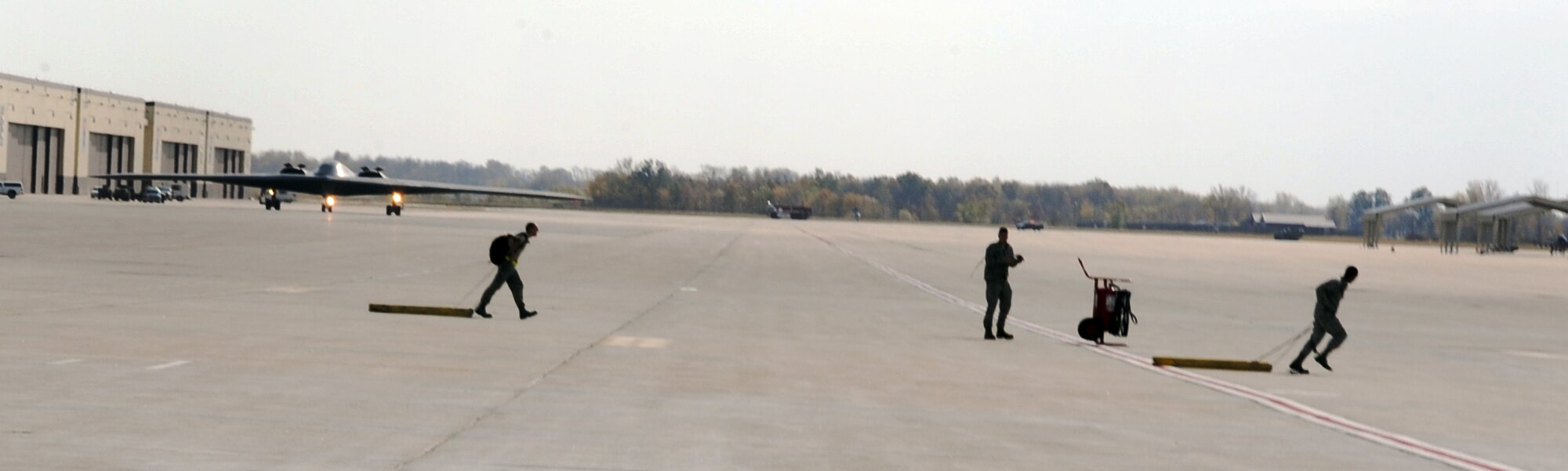 WHITEMAN AIR FORCE BASE, Mo -- 509th Aircraft Maintenance Squadron, maintainers and crew chiefs, prepare to receive a B-2 Stealth Bomber during Global Thunder 12 exercise Oct. 25.  The exercise provides unique training opportunities for component, task force, unit forces, and command posts to deter, and if necessary defeat a military attack against the United States and to employ forces as directed by the president. (U.S. Air Force photo/Senior Airman Laura Goodgame) 