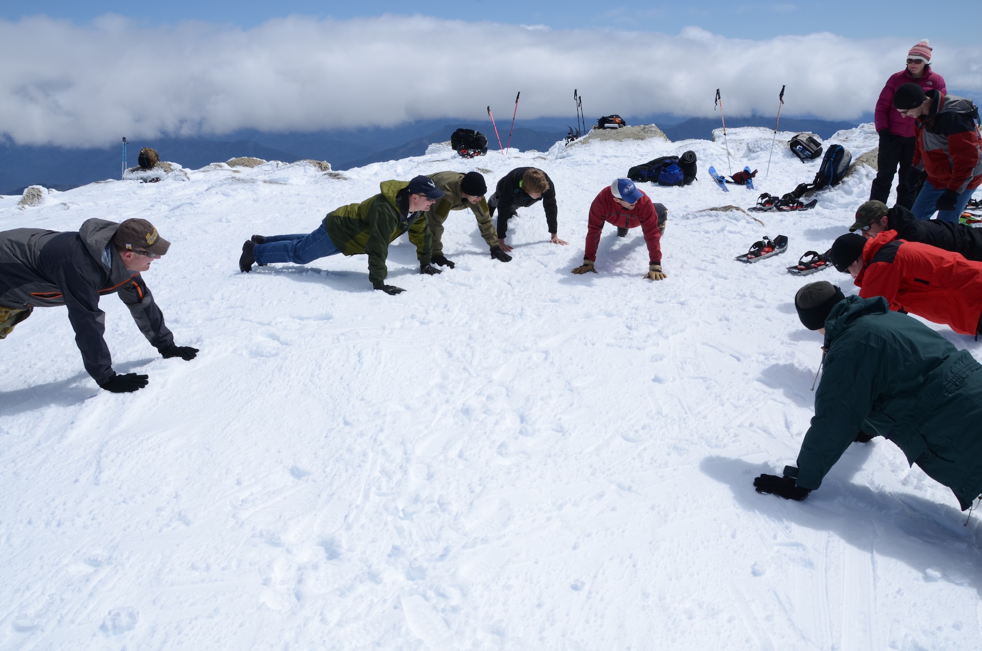 American and Australian service members perform pushups atop Mount Kosciuszko in New South Wales, Australia, Oct. 3, 2011. The team climbed the 7,310-foot mountain as part of the Seven Summits Challenge to raise funds for families of fallen Airmen. (Courtesy photo)