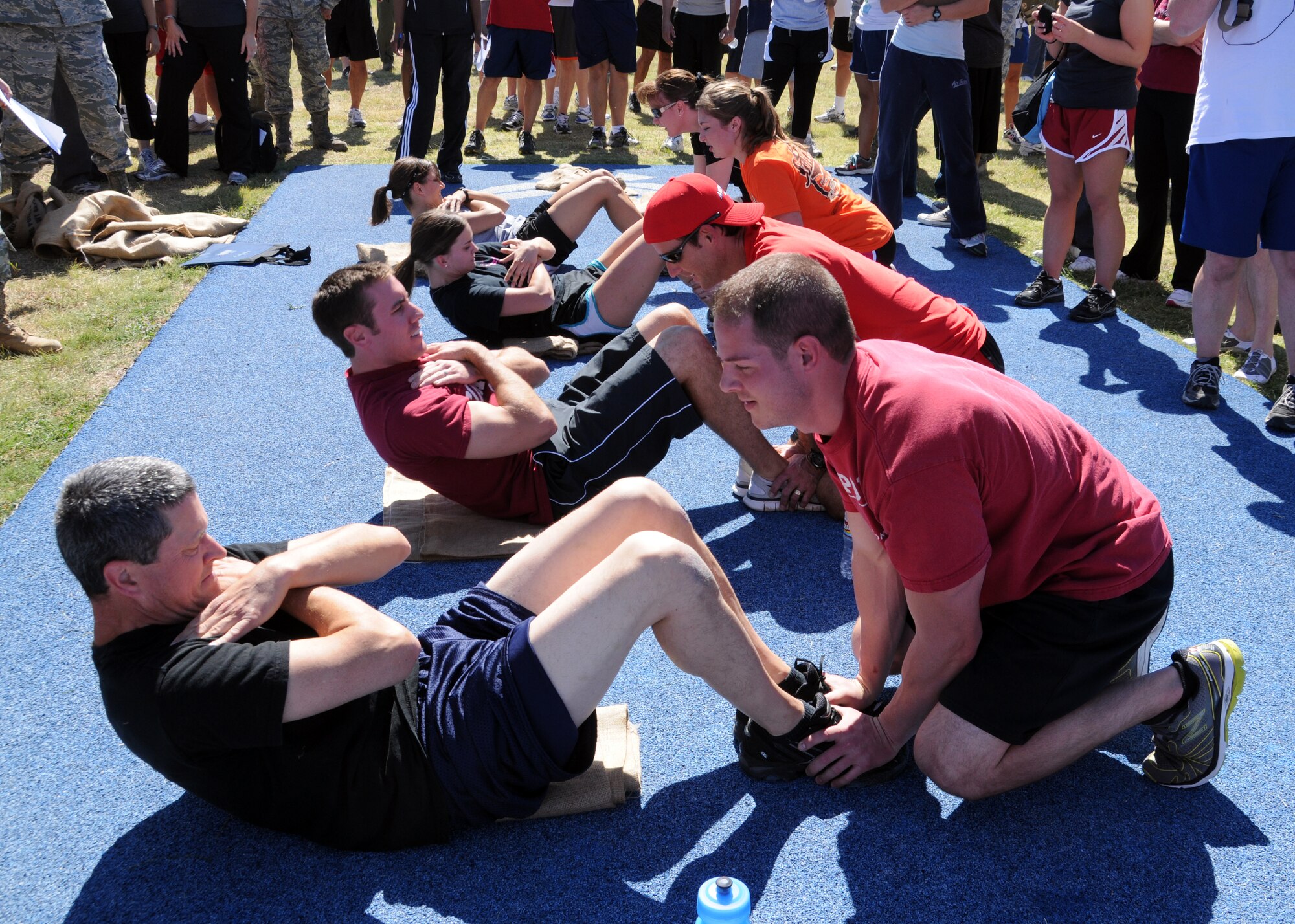 Col. Glen Baker, Commander of the 137th Air Refueling Wing, competes against his fellow wingmen during the push-ups and sit-ups competition. The base Olympics is one of the many events slated to occur on base being hosted and ran by the base mentorship program and the human resources advisors. For more mentorship program up-coming event information please call Master Sgt. Scherryl Coulter at 686-5276.  
(U.S. Air Force Photo by Senior Airman Patricia Baker/Released)