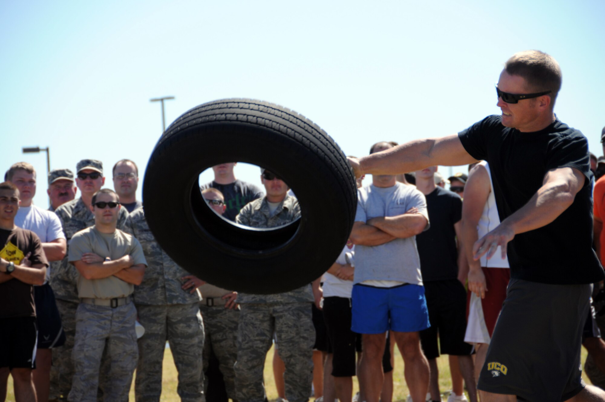 Tech. Sgt. Benjamin Cowart, assigned to the 137th Maintenance Group,  hurls a tire downrange in the tire toss competition during the base Olympics. One at a time, Cowart and other competitors had to find their own unique way of tossing the tire as far as they could.

(U.S. Air Force Photo by Staff Sgt Caroline Hayworth/Released)