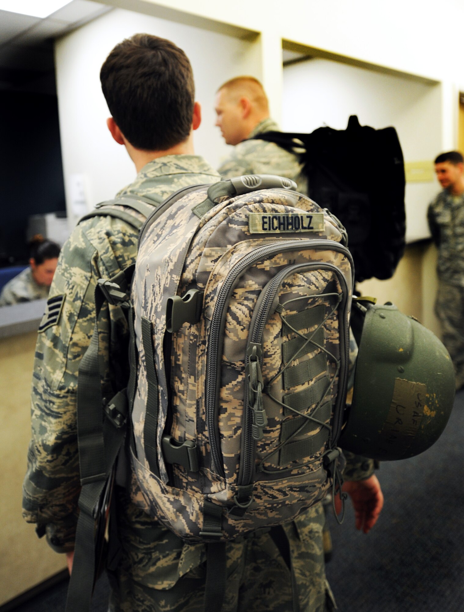 U.S. Air Force Staff Sgt. Uriah Eichholz, 77th Fighter Squadron intelligence analyst, stands in line to process through the deployment line at Shaw Air Force Base, S.C., Oct. 26, 2011. This week the Phase I exercise Sea Lion 12-01 kicked off giving Shaw Airmen the opportunity to train and simulate the process before deploying. (U.S. Air Force photo by Airman 1st Class Tabatha Duarte/Released)