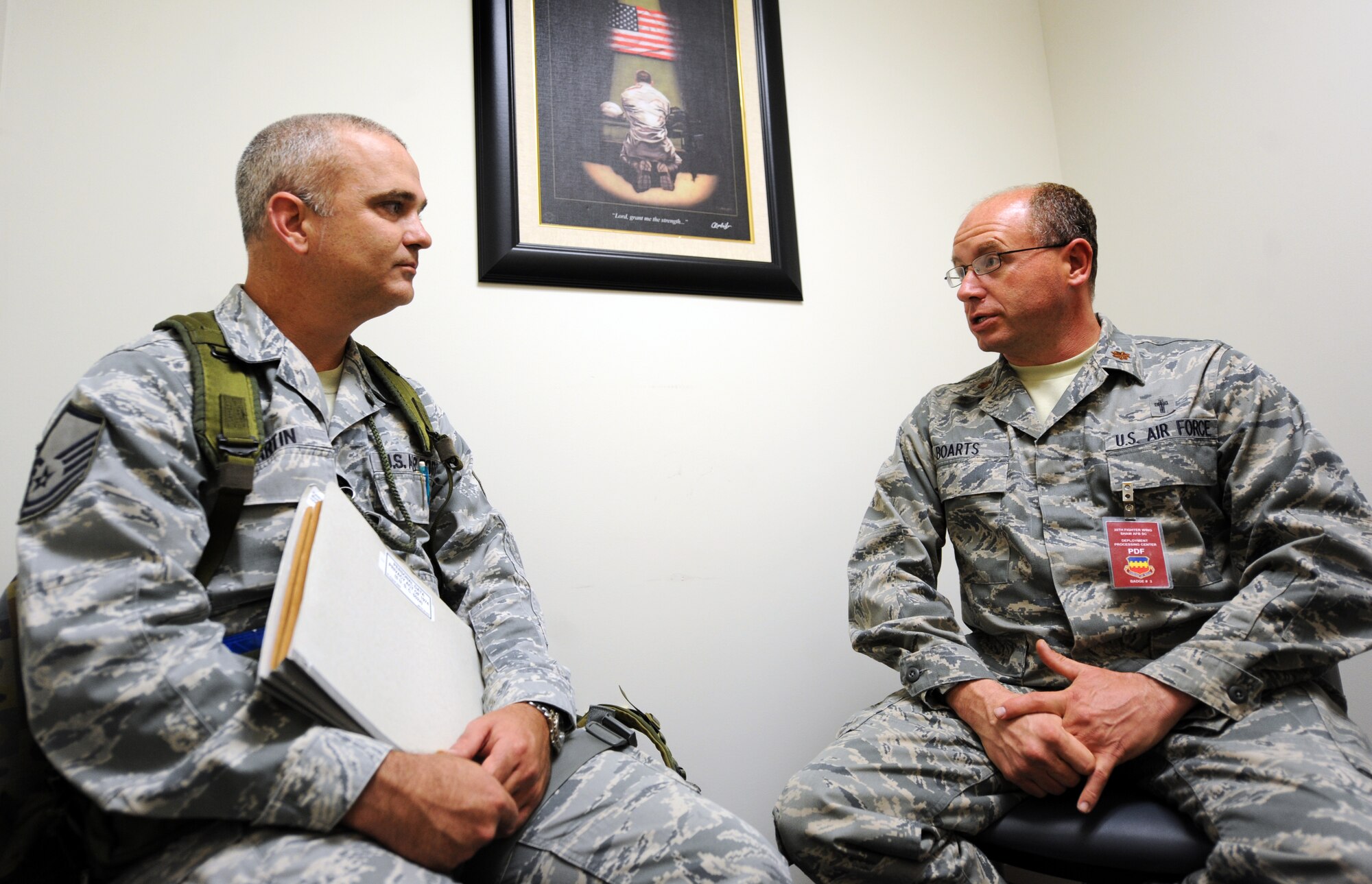 U.S. Air Force Maj. Matthew Boarts, 20th Fighter Wing chaplain, counsels Master Sgt. Bruce Martin, 20th Equipment Maintenance Squadron aircraft structural maintenance section chief, before he processes through the line at Shaw Air Force Base, S.C., Oct. 26, 2011. This week the Phase I exercise Sea Lion 12-01 kicked off giving Shaw Airmen the opportunity to train and simulate the process before deploying. (U.S. Air Force photo by Airman 1st Class Tabatha Duarte/Released)