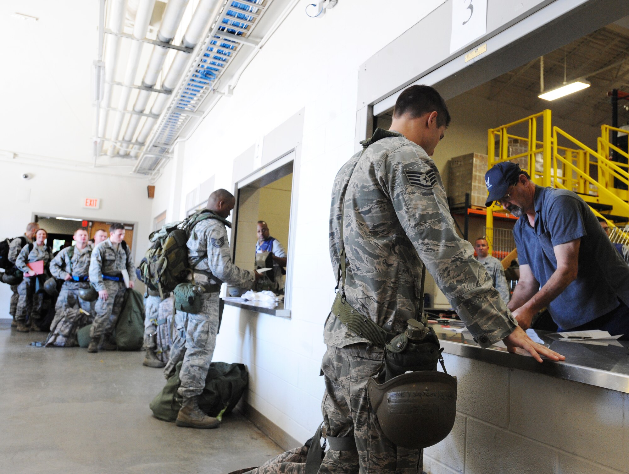 U.S. Air Force Airmen process through the line and make sure they have all the necessary gear to process through the line at Shaw Air Force Base, S.C., Oct. 26, 2011. This week the Phase I exercise Sea Lion 12-01 kicked off giving Shaw Airmen the opportunity to train and simulate the process before deploying. (U.S. Air Force photo by Airman 1st Class Tabatha Duarte/Released)