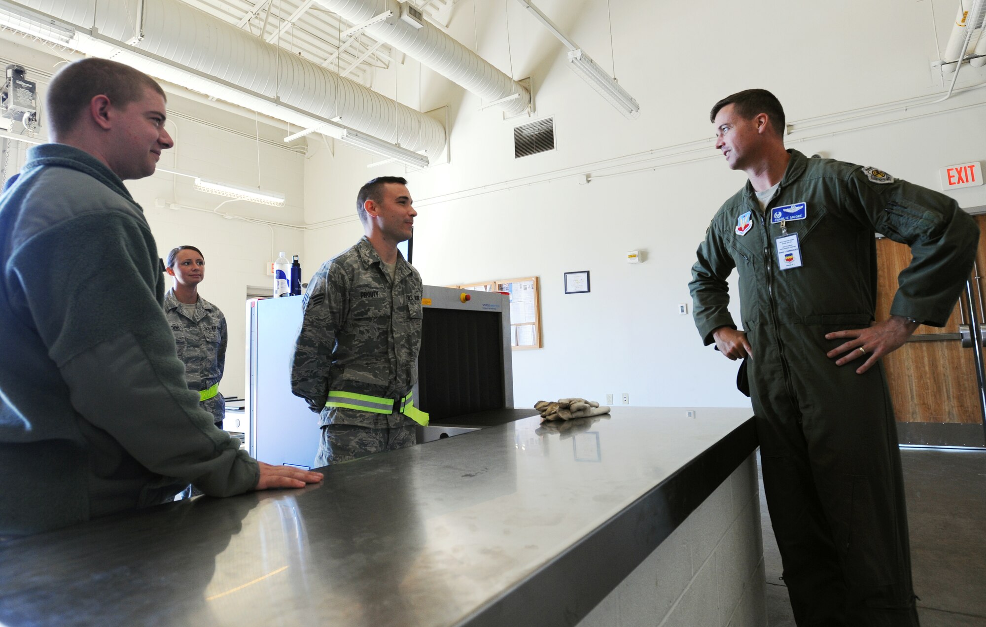 U.S. Air Force Col. Charlie Moore, 20th Fighter Wing commander, speaks with Senior Airman Bradley Prouty, 20th Communications Squadron cyber transport technician, and Airman 1st Class Jonathan Passman, 20th Communications Squadron knowledge operation management, at Shaw Air Force Base, S.C., Oct. 26, 2011. This week the Phase I exercise Sea Lion 12-01 kicked off giving Shaw Airmen the opportunity to train and simulate the process before deploying. (U.S. Air Force photo by Airman 1st Class Tabatha Duarte/Released)