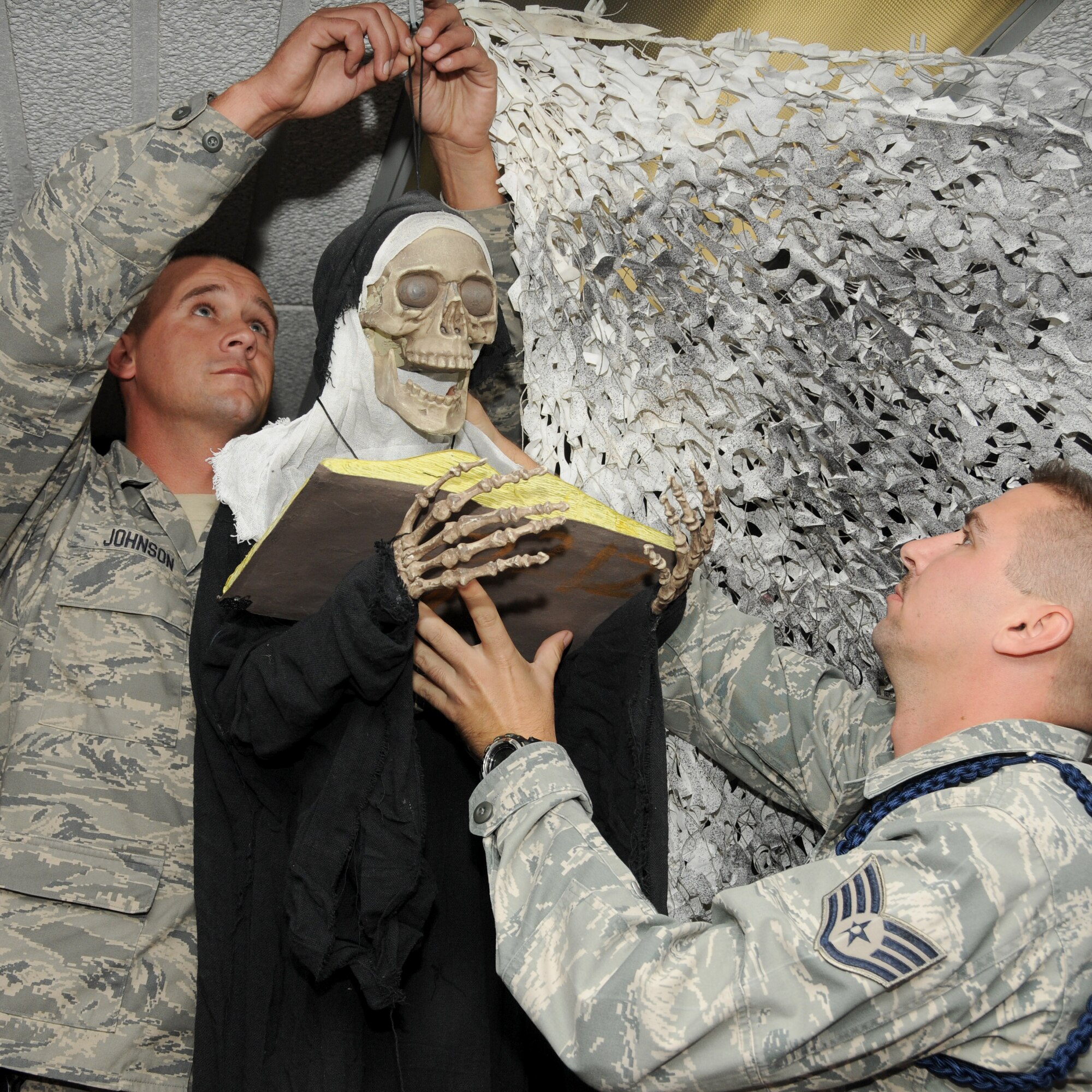 Left, Staff Sgt. Jonathan Johnson, 81st Security Forces Squadron, and Staff Sgt. Chris Freimann, 335th Training Squadron, hang a prop inside the haunted hangar Oct. 20, 2011, Keesler Air Force Base, Miss.  Hangar 3 is being transformed into a hall of horrors for a Keesler Halloween tradition dating back nearly 25 years. The vacant hangar across from Thomson Hall is the site for “The Forgotten,” a Halloween haunted house sponsored by the 335th Training Squadron and the 81st Security Forces
Squadron, Oct. 26-31. Hours vary according to the day. Admission is $10 for adults and $5 for children, but the event isn’t recommended for young children. There’s a $2 discount per ticket admission with a  bowling receipt from Gaudé Lanes through Oct. 31. For more information,  visit www.Facebook.com/KeeslerHH.  (U.S. Air Force photo by Kemberly Groue)
