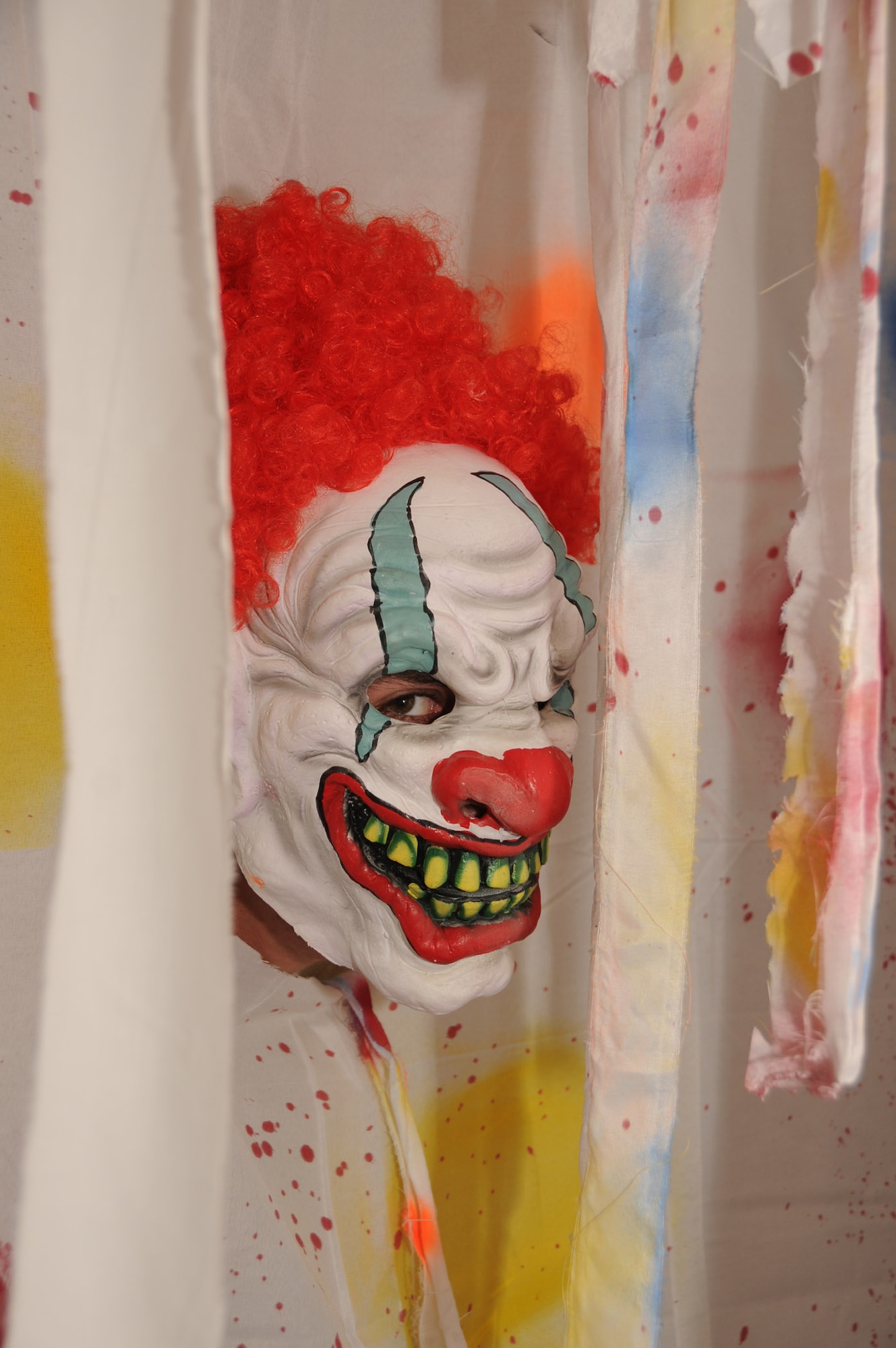 Staff Sgt. Chris Freimann, 335th Training Squadron, wears a clown mask inside the haunted hangar Oct. 20, 2011, Keesler Air Force Base, Miss.  Hangar 3 is being transformed into a hall of horrors for a Keesler Halloween tradition dating back nearly 25 years. The vacant hangar across from Thomson Hall is the site for “The Forgotten,” a Halloween haunted house sponsored by the 335th Training Squadron and the 81st Security Forces Squadron, Oct. 26-31. Hours vary according to the day. Admission is $10 for adults and $5 for children, but the event isn’t recommended for young children. There’s a $2 discount per ticket admission with a bowling receipt from Gaudé Lanes through Oct. 31. For more information,  visit www.Facebook.com/KeeslerHH.  (U.S. Air Force photo by Kemberly Groue)