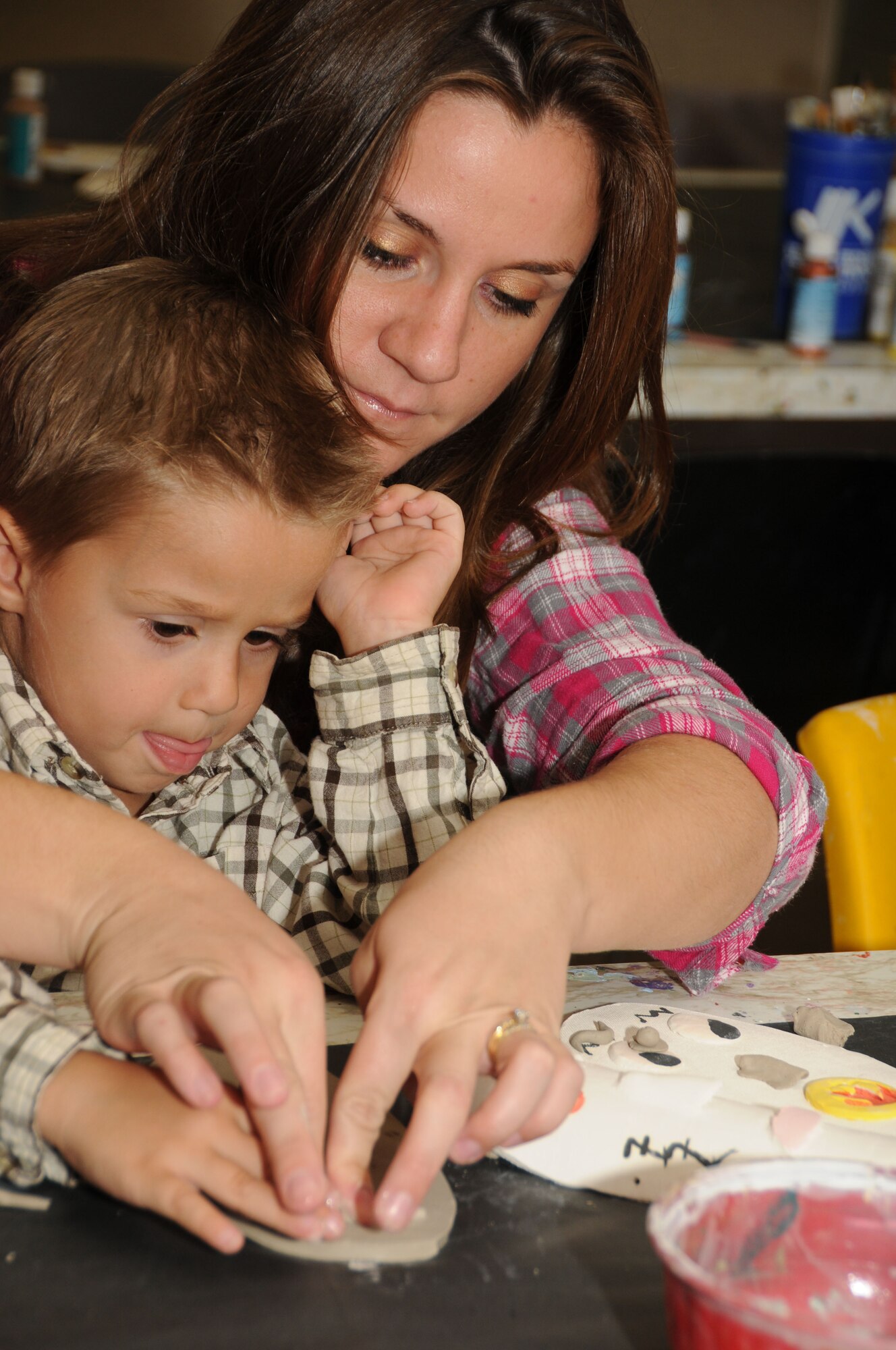 Three-year-old Gabriel Livingston and his mom, Amanda, work together to decorate a mask made out of clay during a "make a mask" event at the arts and crafts center Oct. 22, 2011, at Keesler Air Force Base, Miss.  Gabriel's dad is 2nd Lt. Jeffrey Livingston, 81st Force Support Squadron.  (U.S. Air Force photo by Kemberly Groue)