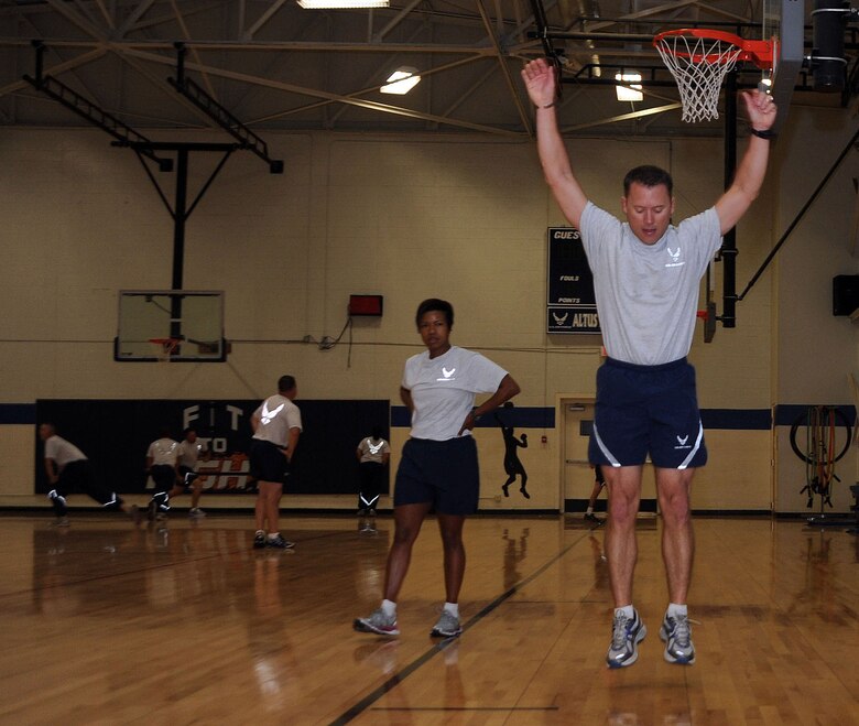 ALTUS AIR FORCE BASE, Okla. – Col. Casey Eaton, 97th Air Mobility Wing vice commander, joins a physical training session with the 97th Civil Engineer Squadron at the base fitness center Oct. 21, 2011. The PT program at the 97th CES has led to a consistent 97-98 percent pass rate with over 60 percent in the excellent category. (U.S. Air Force photo by Senior Airman Myles Stepp / 97th Air Mobility Wing Public Affairs / Released)