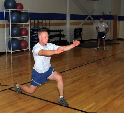ALTUS AIR FORCE BASE, Okla. – Senior Airman Jesse Joseph, 97th Civil Engineer Squadron heating ventilation and air condition technician, performs a lunge at the base fitness center Oct. 21, 2011. Joseph is one of 10 physical training leaders in 97th CES. It is the responsibility of PTLs to teach their fellow Airmen what it takes to stay fit-to-fight by leading their unit’s PT in CES. (U.S. Air Force photo by Senior Airman Myles Stepp / 97th Air Mobility Wing Public Affairs / Released)