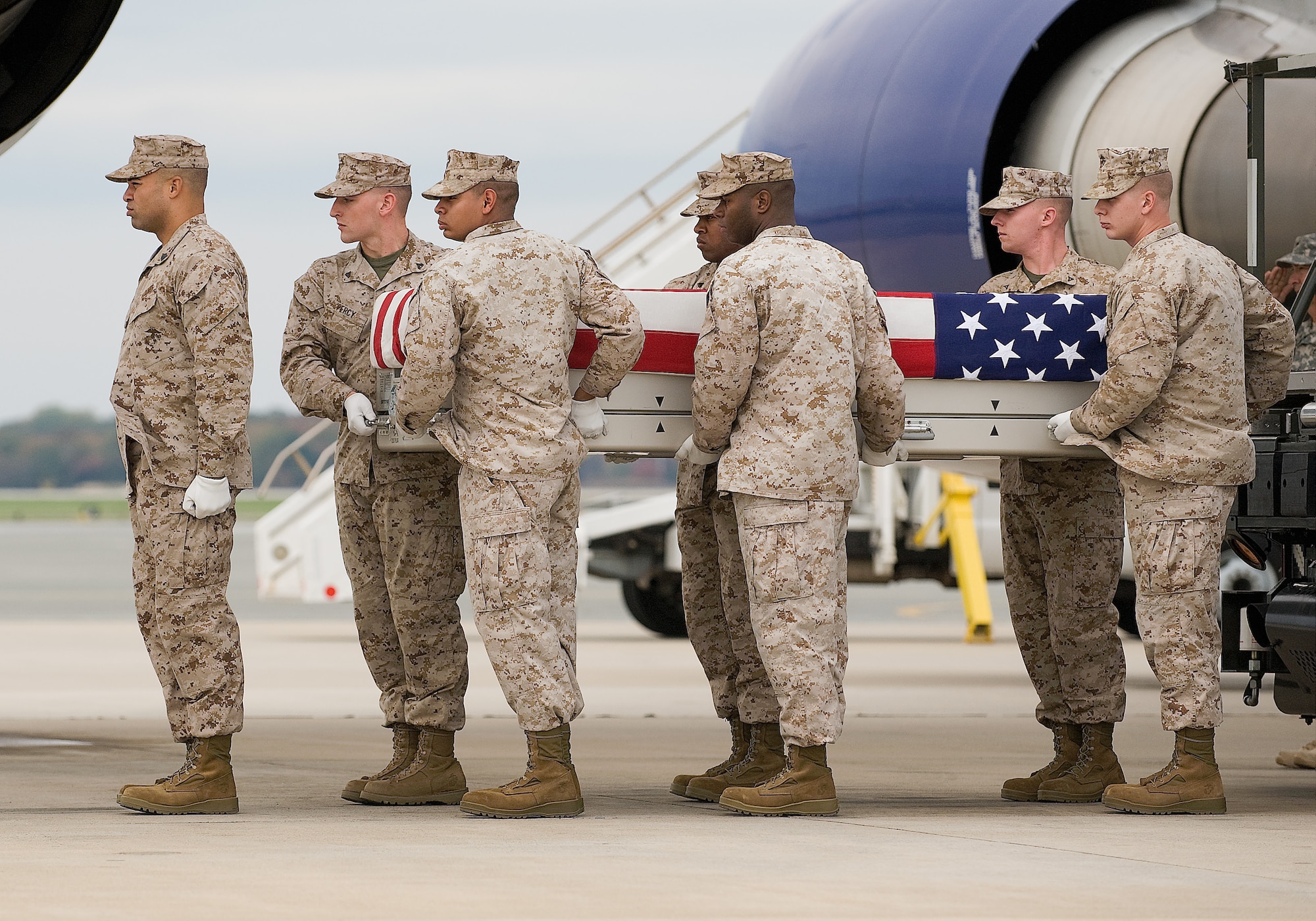 A U.S. Marine Corps carry team transfers the remains of Marine Lance Cpl. Jason N. Barfield, of Ashford, Ala., at Dover Air Force Base, Del., Oct. 26, 2011. Barfield was assigned to the 3rd Combat Engineer Battalion, 1st Marine Division, I Marine Expeditionary Force, Marine Corps Air Ground Combat Center, Twentynine Palms, Calif. (U.S. Air Force photo/Steve Kotecki)