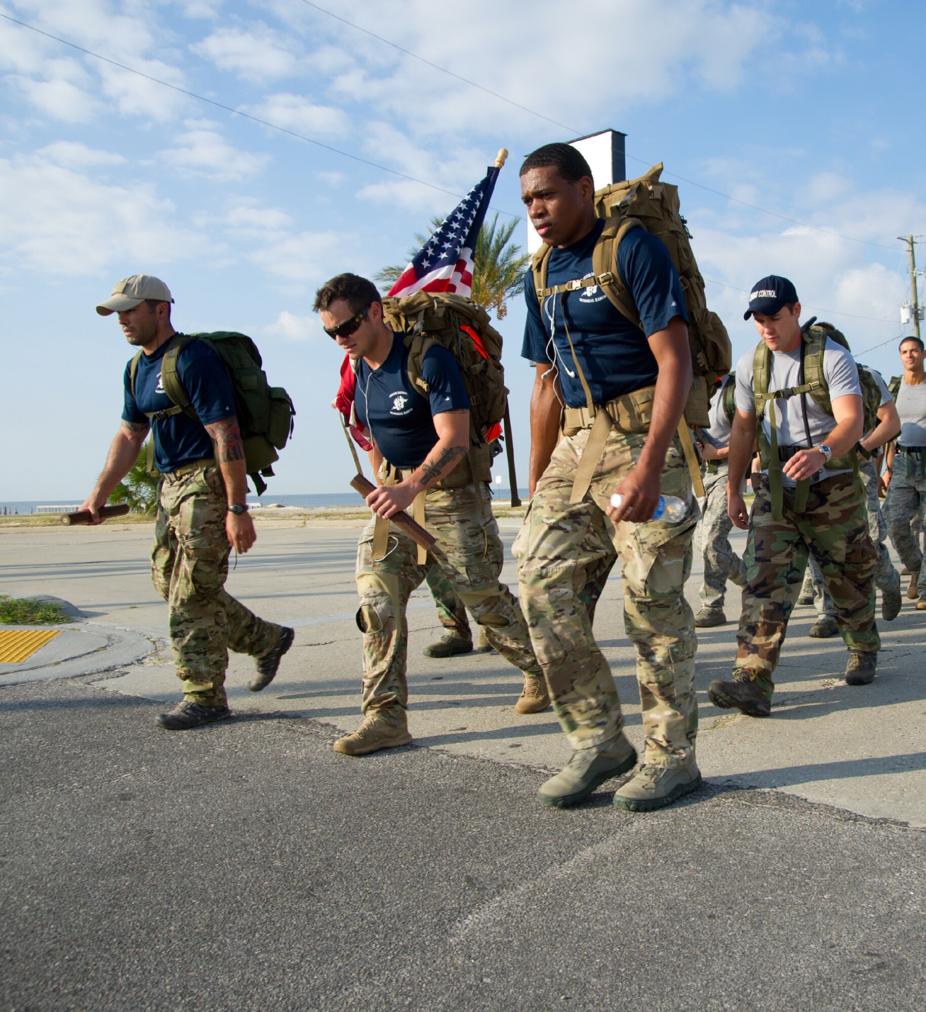 Members of the 812-mile Tim Davis Memorial March pass by Keesler Air Force Base, Miss., as they make their way along U.S. Highway 90 in Biloxi Oct. 24, 2011. The march honors special tactics Airmen who have died fighting in Iraq and Afghanistan. Nearly 40 combat control instructors and trainees from the 334th Training Squadron joined the march as it neared Keesler and other Airmen lined the highway to salute the flag. The march began at Lackland Air Force Base, Texas, Oct. 16 and ended at the Special Tactics Training Squadron at Hurlburt Field, Fla., Oct. 26.  (U.S. Air Force photo by Adam Bond)