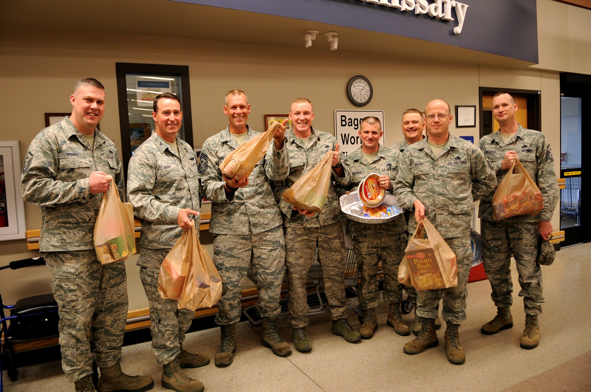 Grand Forks Air Force Base first sergeants pose for a photo with Col. Tim Bush (2nd from left), 319th Air Base Wing commander, and Command Chief Master Sgt. Dave Carlson (3rd from left), 319th Air Base Wing, after purchasing items to donate to Operation Warmheart on Oct. 25. Operation Warmheart is a community outreach program of the GFAFB First Sergeant Council that collects donations to provide a no-cost Thanksgiving dinner for Airmen on base.  Donations are being accepted at the base commissary. (U.S. Air Force photo by Senior Airman Amanda N. Stencil)