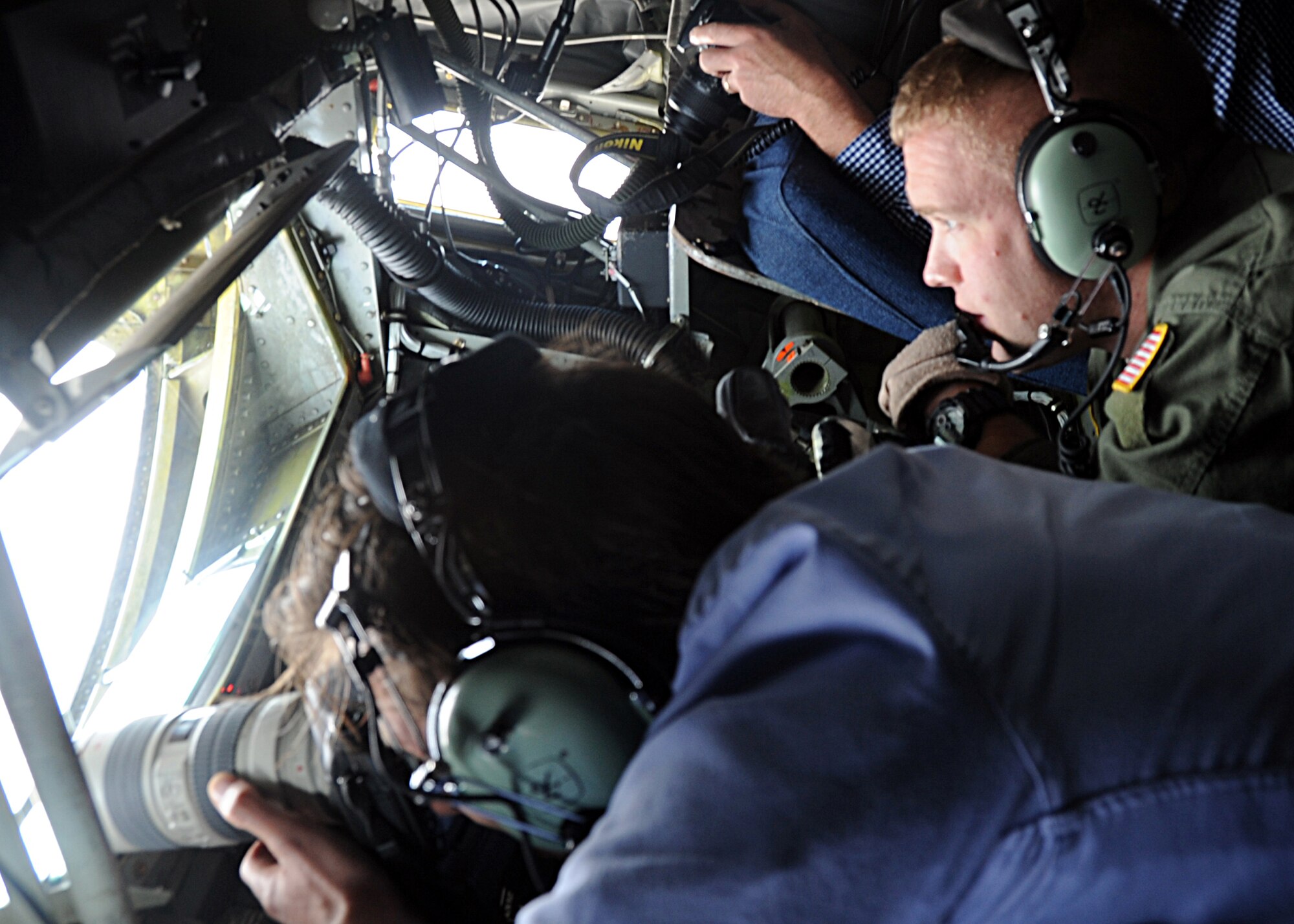 ALTUS AIR FORCE BASE, Okla. -- Ramon Wenink, Global Aviation Review press journalist from the Netherlands, photographs aerial refueling operations of a B-1B Lancer and C-17 Globemaster III while Tech. Sgt. Daniel Maas, 54th Air Refueling Squadron boom operator instructor, directs aircraft into camera view. GAR received special permission to be part of a mission to document aerial refueling operations for an international article they are writing about airborne refueling operations. (U.S. Air Force photo by Master Sgt. Brian Boisvert / 97th Air Mobility Wing)