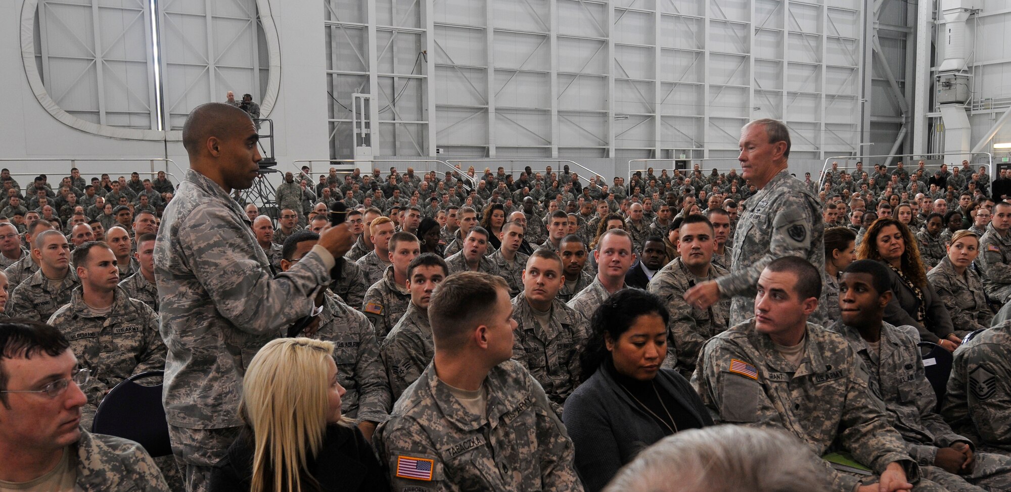 1st Lt. Aaron Green asks Chairman of the Joint Chiefs of Staff General Martin Dempsey a question after Dempsey addressed Soldiers, Airmen, Sailors, Marines and civilians at a town hall meeting in hanger 20 on Joint Base Elmendorf-Richardson, Alaska, Oct. 25, 2011. More than 600 military and civilian members listened to his goals and challenges for the Department of Defense. General Dempsey took question from the audience following his remarks. Green is assigned to the 773d Logistics Readiness Squadron. (U.S. Air Force photo/Steve White)