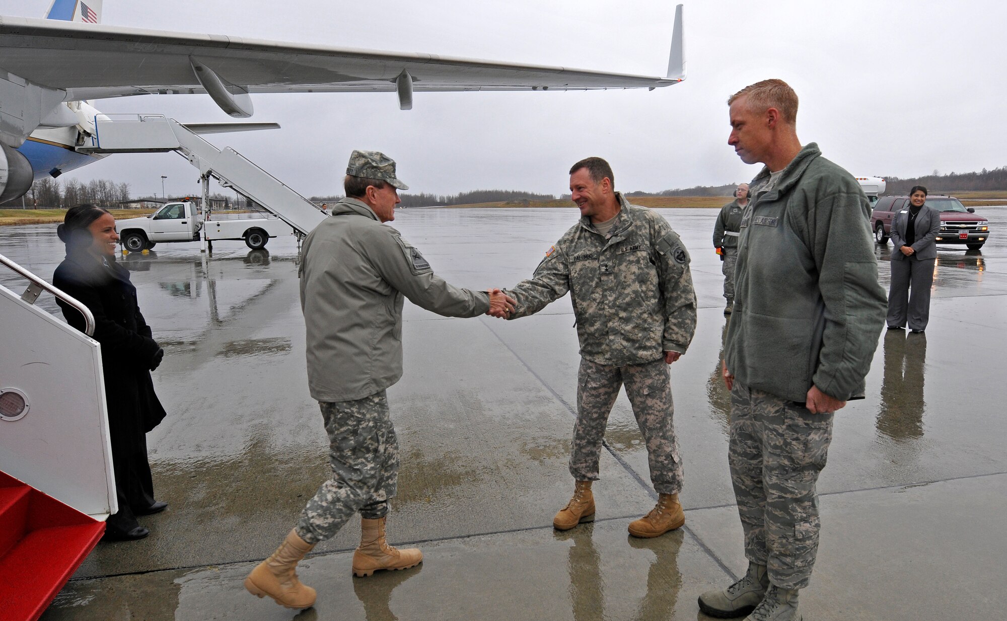 Maj. Gen. Raymond P. Palumbo, center, and Chief Master Sgt. Michael Warner greet the 18th Chairman of the Joint Chiefs of Staff General Martin Dempsey upon his arrival at Joint Base Elmendorf-Richardson, Alaska, Oct. 25, 2011. Dempsey addressed Soldiers, Airmen, Sailors, Marines and civilians at a town hall meeting in hanger 20 here. More than 600 military and civilian members listen to his goals and challenges for the Department of Defense. General Dempsey took question from the audience following his remarks. (U.S. Air Force photo/Steve White)