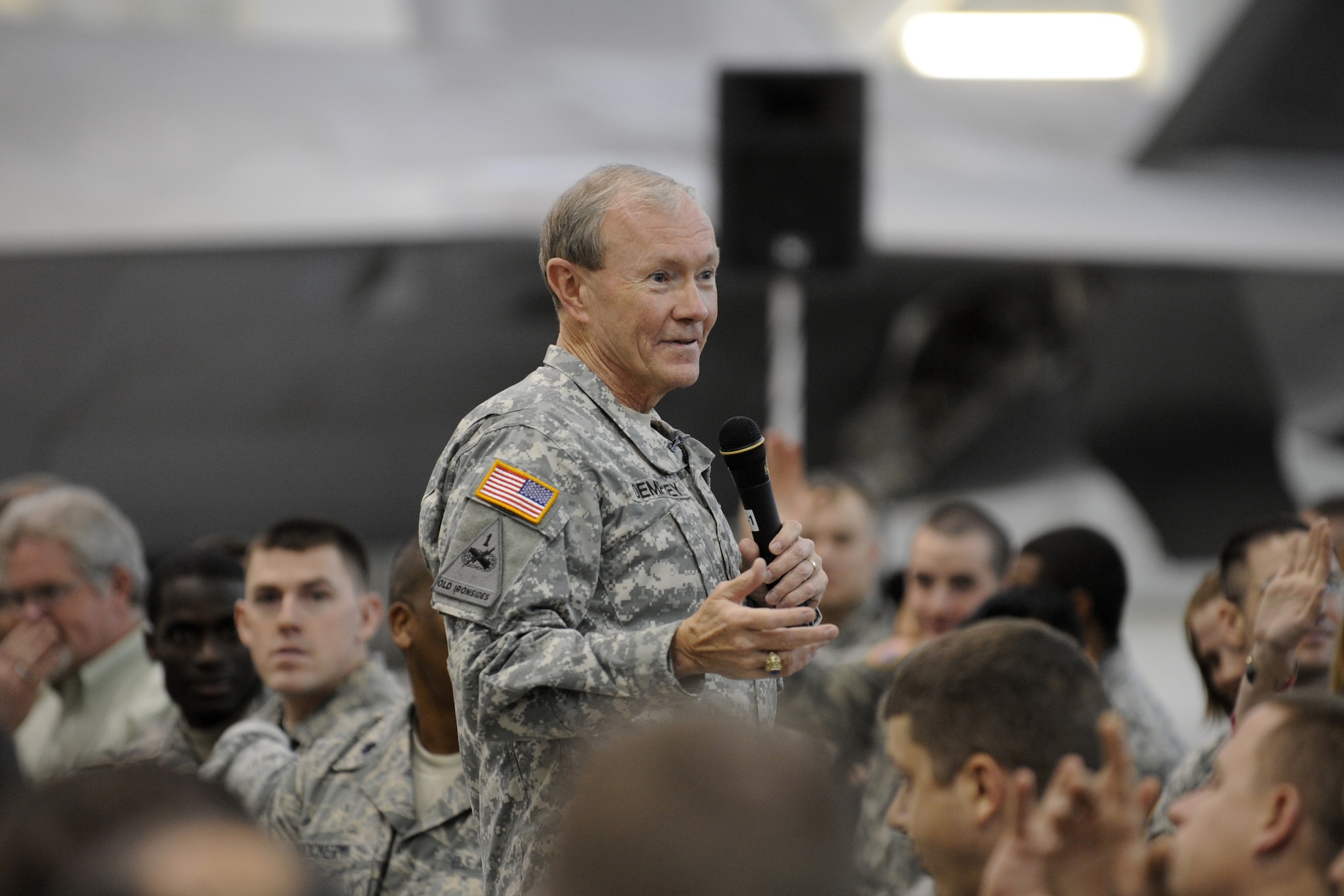 The 18th Chairman of the Joint Chiefs of Staff General Martin Dempsey addresses Soldiers, Airmen, Sailors, Marines and civilians at a town hall meeting in hanger 20 on Joint Base Elmendorf-Richardson, Alaska, Oct. 25, 2011. More than 600 military and civilian members listened to his goals and challenges for the Department of Defense. General Dempsey took question from the audience following his remarks. (U.S. Air Force photo/Steve White)