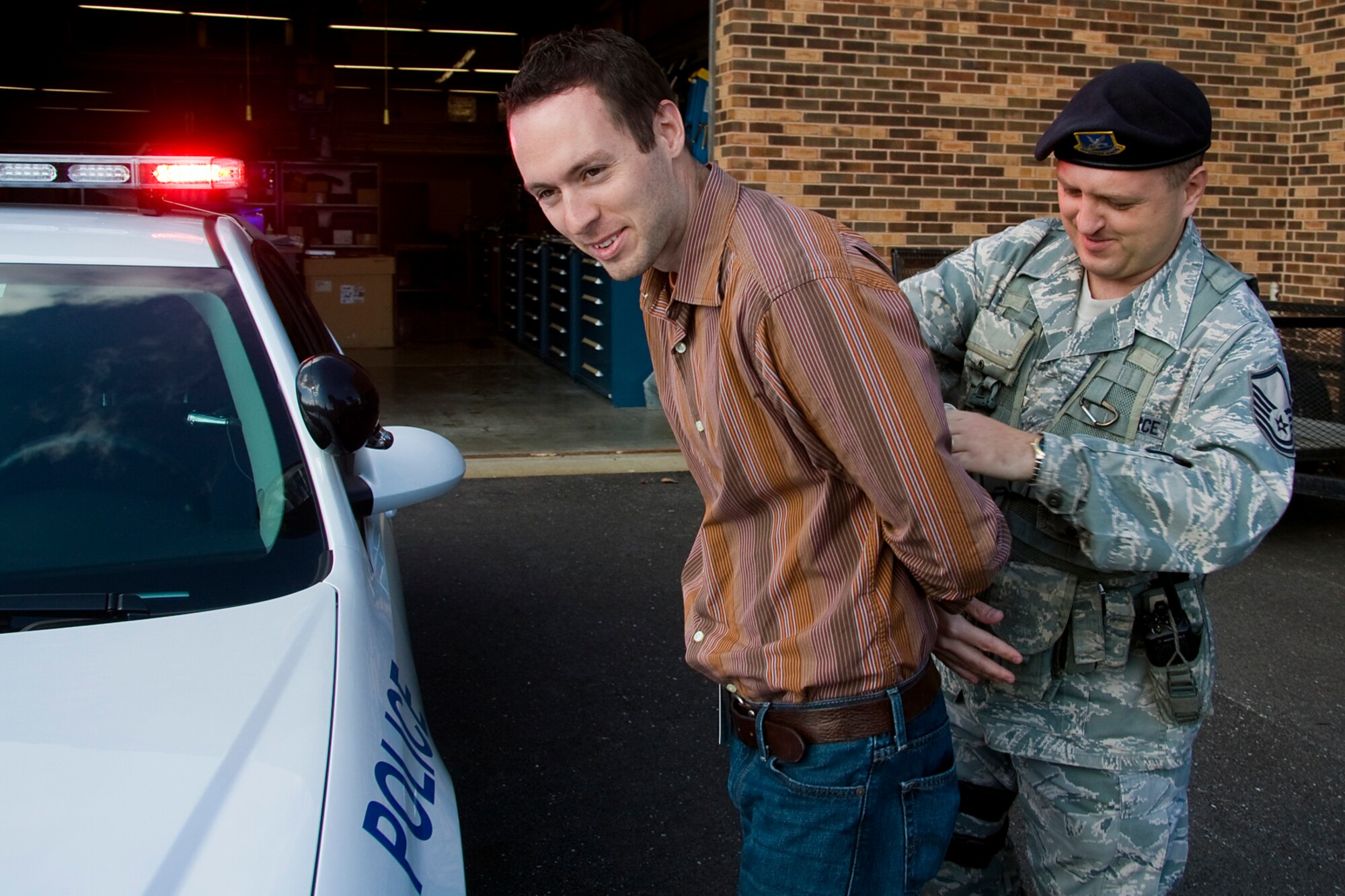 GRISSOM AIR RESERVE BASE, Ind. -- Master Sgt. William A. Mezel Jr. handcuffs Rocky Walls, 434th Mission Support Group honorary commander, during a special demonstration put on for Grissom's honorary commanders Oct. 14. Mezel is a day shift supervisor with the 434th Security Forces Squadron, which is part of the 434th MSG. The honorary commanders visited the base to learn more about Grissom so they can share that information with their local communities. (U.S. Air Force photo/Tech. Sgt. Mark R. W. Orders-Woempner)    
