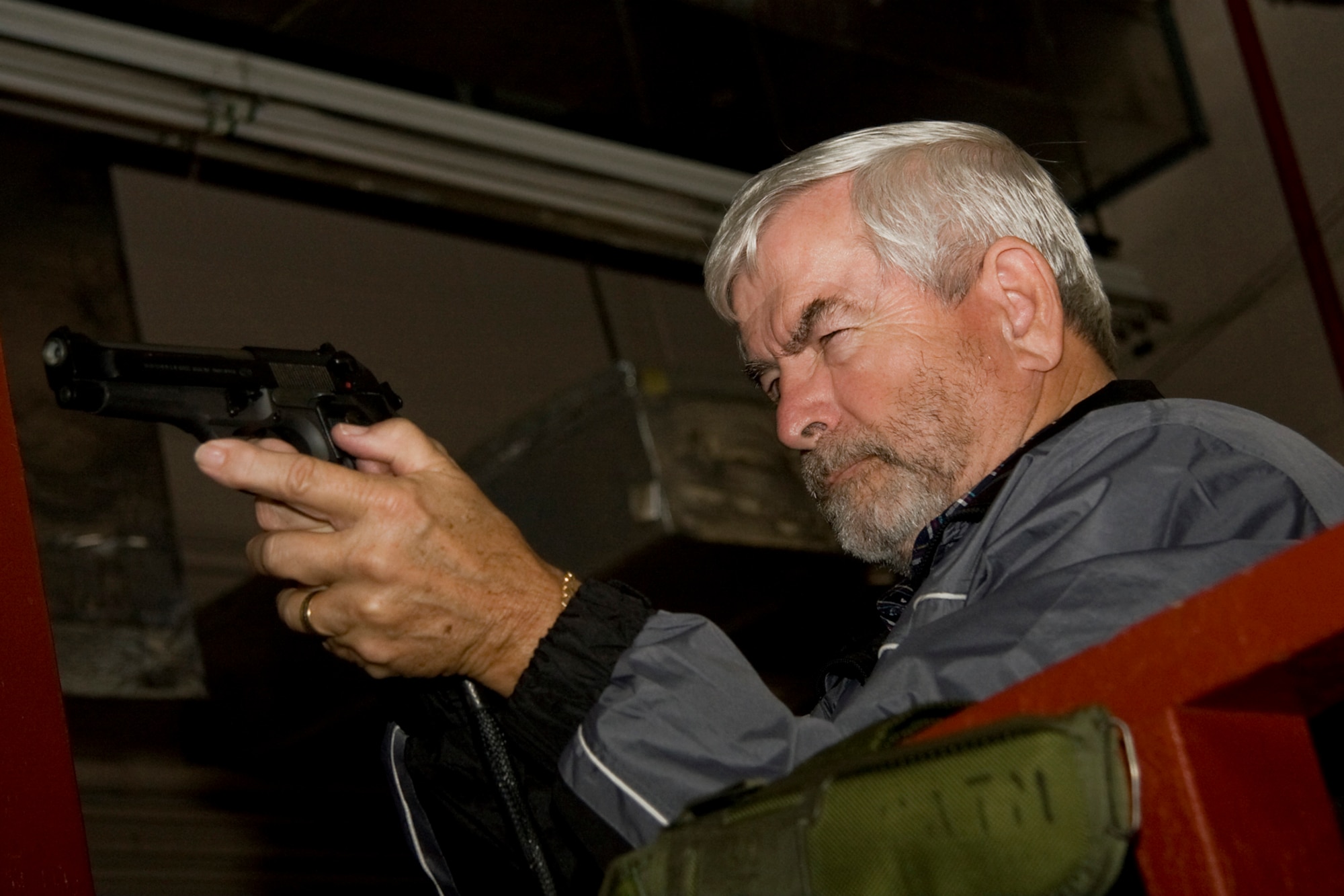 GRISSOM AIR RESERVE BASE, Ind. -- Hal Job, 434th Operations Group honorary commander, takes aim down the barrel of an M-9 pistol during a special firearms simulator demonstration here Oct. 14. Job, along with Grissom's other honorary commanders visited the base that day to learn more about the 434th Mission Support Group. The honorary commander program at Grissom is just one of several community outreach programs aimed at educating the public about Grissom's mission and impact on the community.  (U.S. Air Force photo/Tech. Sgt. Mark R. W. Orders-Woempner)    
