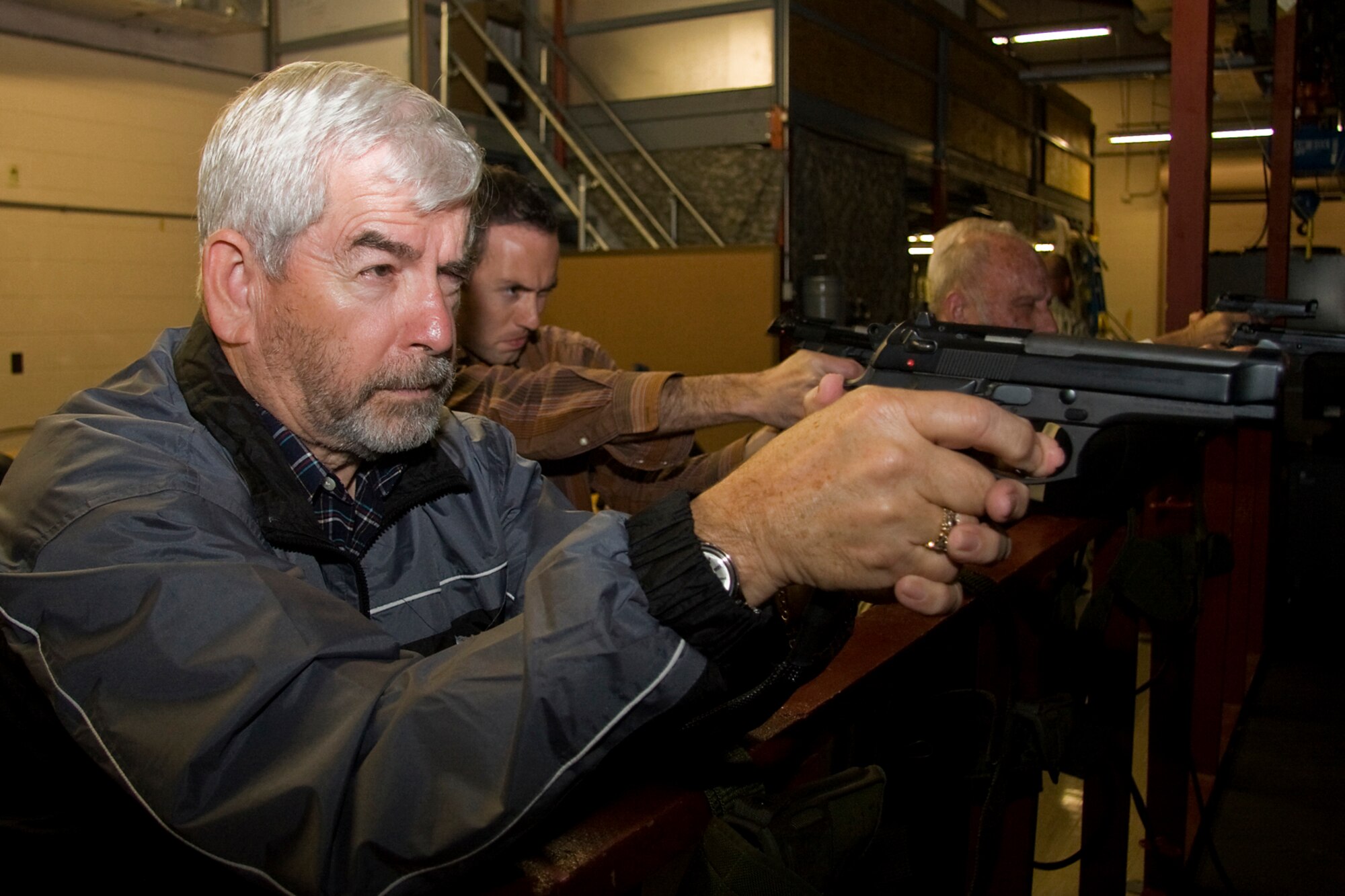 GRISSOM AIR RESERVE BASE, Ind. -- Hal Job, 434th Operations Group honorary commander, takes aim down the barrel of an M-9 pistol during a special firearms simulator demonstration here Oct. 14. Job, along with Grissom's other honorary commanders visited the base that day to learn more about the 434th Mission Support Group. The honorary commander program at Grissom is just one of several community outreach programs aimed at educating the public about Grissom's mission and impact on the community.  (U.S. Air Force photo/Tech. Sgt. Mark R. W. Orders-Woempner)    
