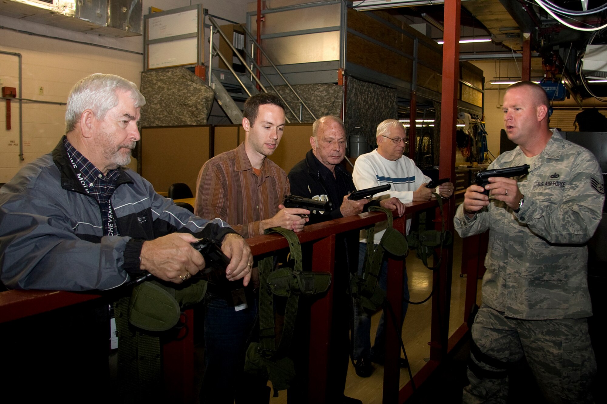 GRISSOM AIR RESERVE BASE, Ind. -- Staff Sgt. Timothy Boggs, 434th Security Forces Squadron fire team member, instructs Grissom's honorary commanders on the functions of an M-9 pistol during a special firearms demonstration Oct. 14. From left to right are Hal Job, Rocky Walls, John Gilpin and John Stackhouse. They all visited the base to learn more about the 434th Mission Support Group, which is the parent organization of the 434t SFS. The honorary commander program at Grissom is just one of several community outreach programs aimed at educating the public about Grissom's mission and impact on the community.  (U.S. Air Force photo/Tech. Sgt. Mark R. W. Orders-Woempner)    
