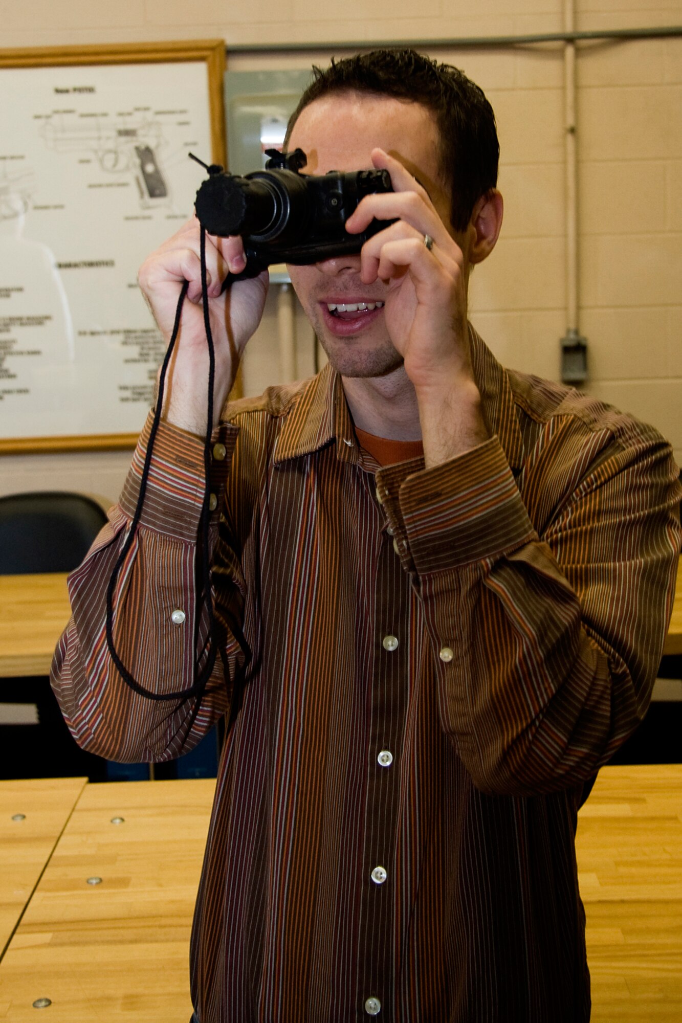 GRISSOM AIR RESERVE BASE, Ind. -- Rocky Walls, 434th Mission Support Group honorary commander, looks through a pair of AN/PVS-7D night vision goggles during a special firearms simulator demonstration here Oct. 14. Walls, along with Grissom's other honorary commanders visited the base that day to learn more about the 434th MSG. The honorary commander program at Grissom is just one of several community outreach programs aimed at educated the public about Grissom's mission and impact on the community.  (U.S. Air Force photo/Tech. Sgt. Mark R. W. Orders-Woempner)    
