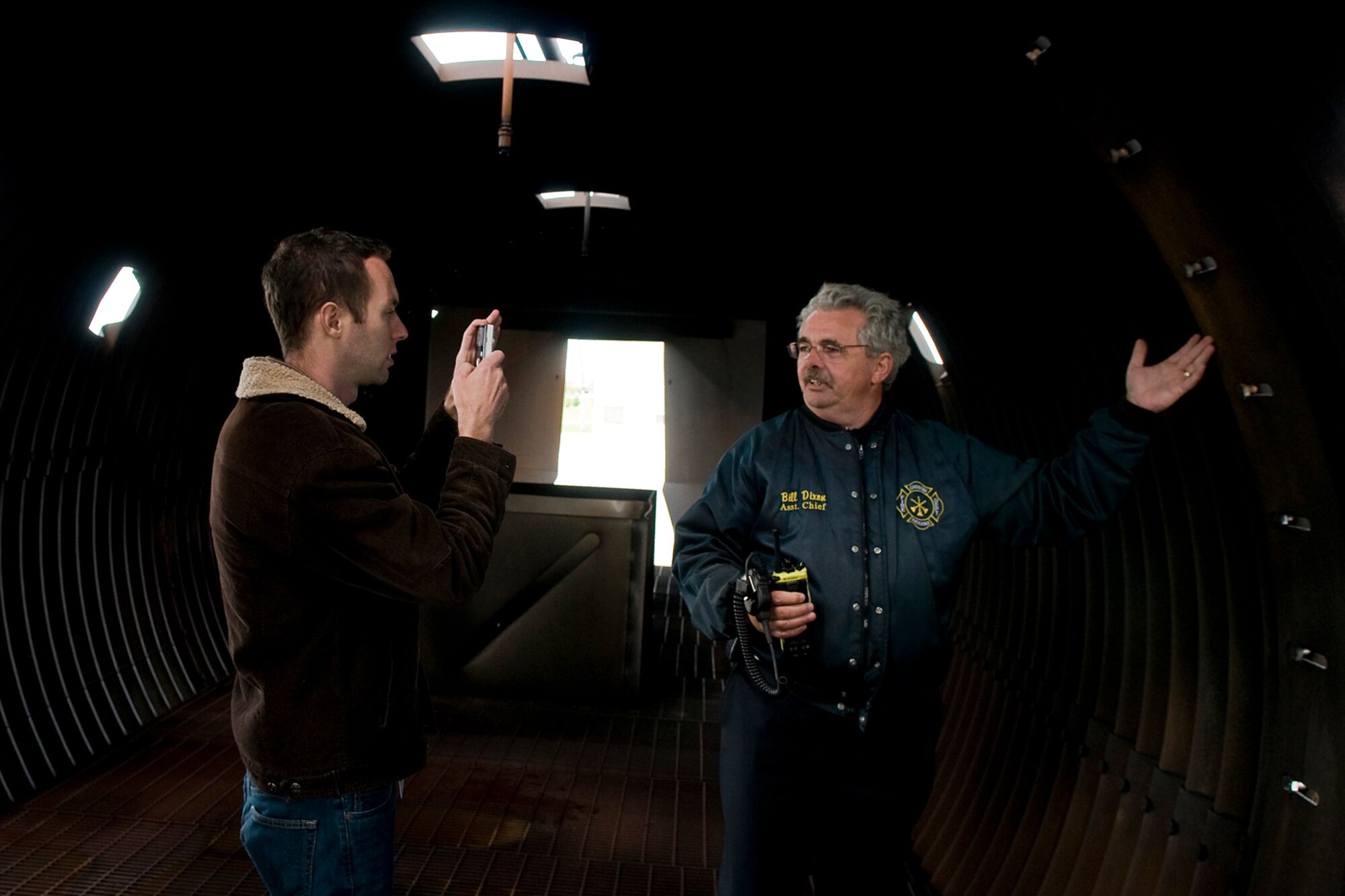 GRISSOM AIR RESERVE BASE, Ind. -- Bill Dixon, Grissom Fire Department assistant fire chief, shows Rocky Walls the inside of an aircraft fire simulator here Oct. 14. Walls, along with Grissom's other honorary commanders, visited the base to learn more about the 434th Mission Support Group. The simulator is used by the GFD and other local fire departments to train for an actual aircraft fire. The honorary commander program at Grissom is just one of several community outreach programs aimed at educating the public about Grissom's mission and impact on the community.  (U.S. Air Force photo/Senior Airman Jami K. Lancette)    