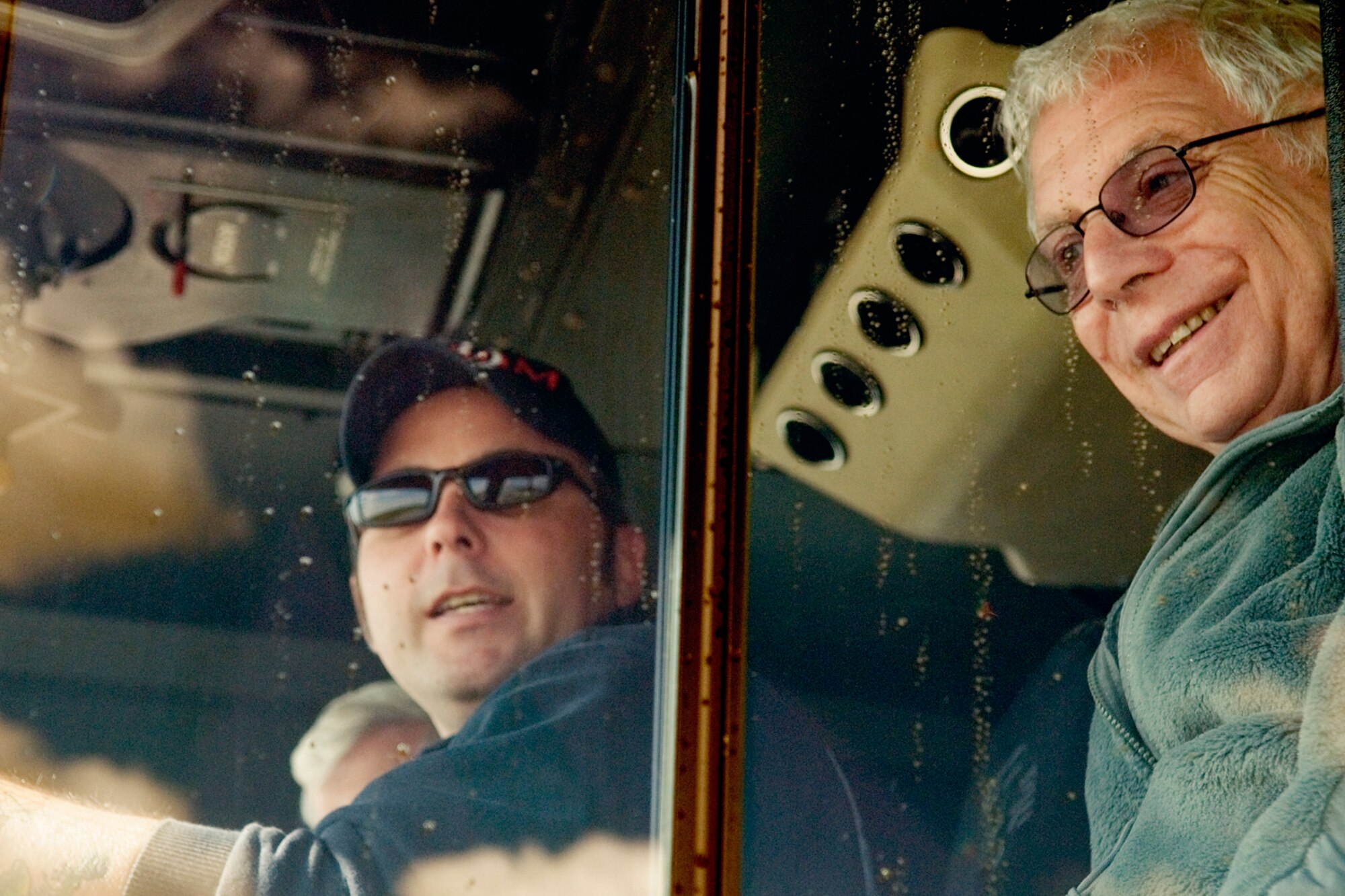 GRISSOM AIR RESERVE BASE, Ind. -- John Stackhouse, right, is all smiles after helping extinguish a simulated aircraft fire here Oct. 14. Driving the fire truck is Grissom firefighter Chris Pribbernow. The honorary commanders visited the base to learn more about the 434th Mission Support Group. The honorary commander program at Grissom is just one of several community outreach programs aimed at educating the public about Grissom's mission and impact on the community.  (U.S. Air Force photo/Senior Airman Jami K. Lancette)    