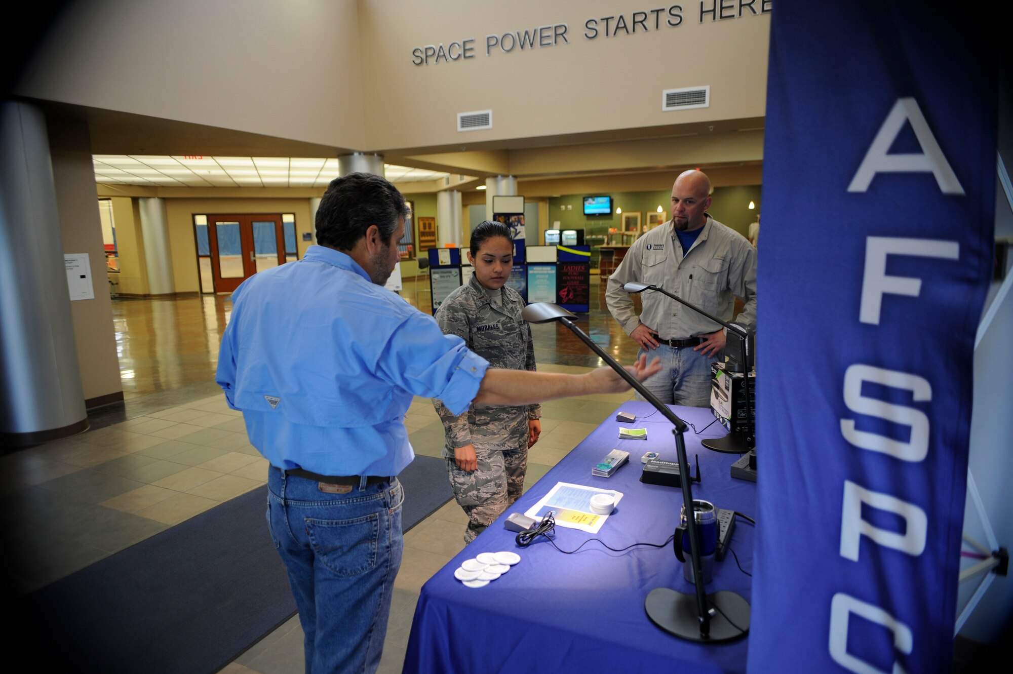 VANDENBERG AIR FORCE BASE, Calif. -- 2nd Lt. Mayrem Morales, a 392nd Training Squadron member, learns about how to reduce energy consumption at the base fitness center Tuesday, Oct. 25, 2011.  The members of the 30th Civil Engineer Squadron Energy Management Team are raising awareness to lower energy consumption by implementing sensors to turn off equipment and lighting fixtures in office areas around base.  (U.S. Air Force photo/Staff Sgt. Andrew Satran) 

 