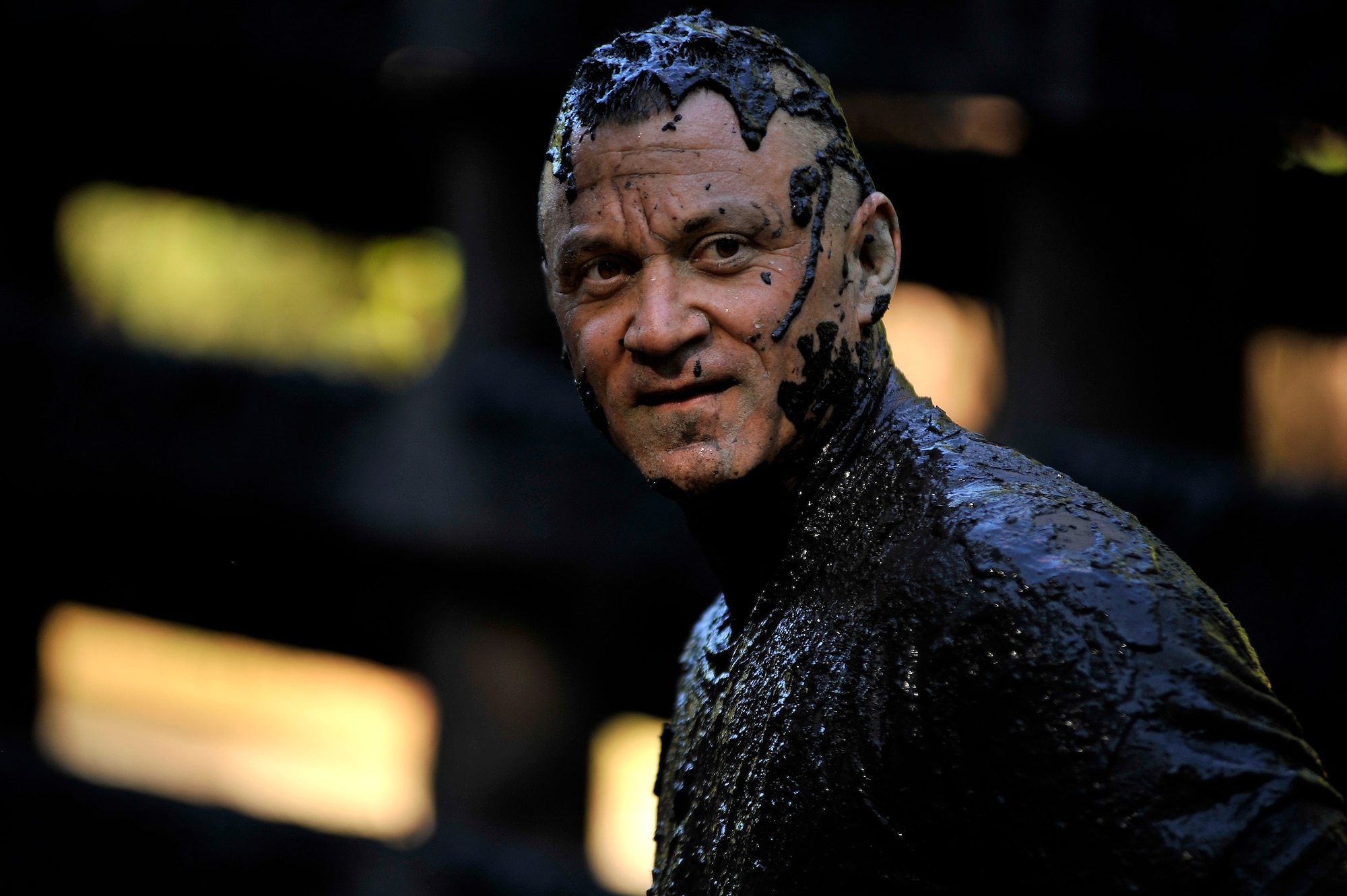 A participant of the U.S. Marine Corps Mud Run stands covered from head to toe in mud as he waits for the rest of his team to catch up with him, Oct. 15, 2011, Columbia, S.C. Participants competed in four person teams in different categories: male, female, co-ed, homeland heroes, military, corporate and JROTC. (U.S. Air Force photo by Senior Airman Kenny Holston/Released)


