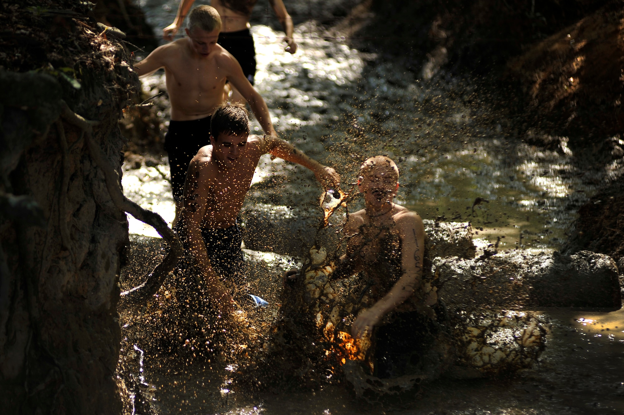 JROTC members splash their way through muddy water as they make their way through one of the many phases of the U.S. Marine Corps Mud Run course, Oct. 15, 2011, Columbia, S.C. The USMC Mud Run is a 5.2-mile course with 36 obstacles that each team needs to maneuver, requiring team work and loads of determination. The 5.2-mile course is an all-terrain race conducted on trails to include mud holes, walls, trenches, and other challenging obstacles that require swimming, crawling, climbing and jumping. (U.S. Air Force photo by Senior Airman Kenny Holston/Released) 


