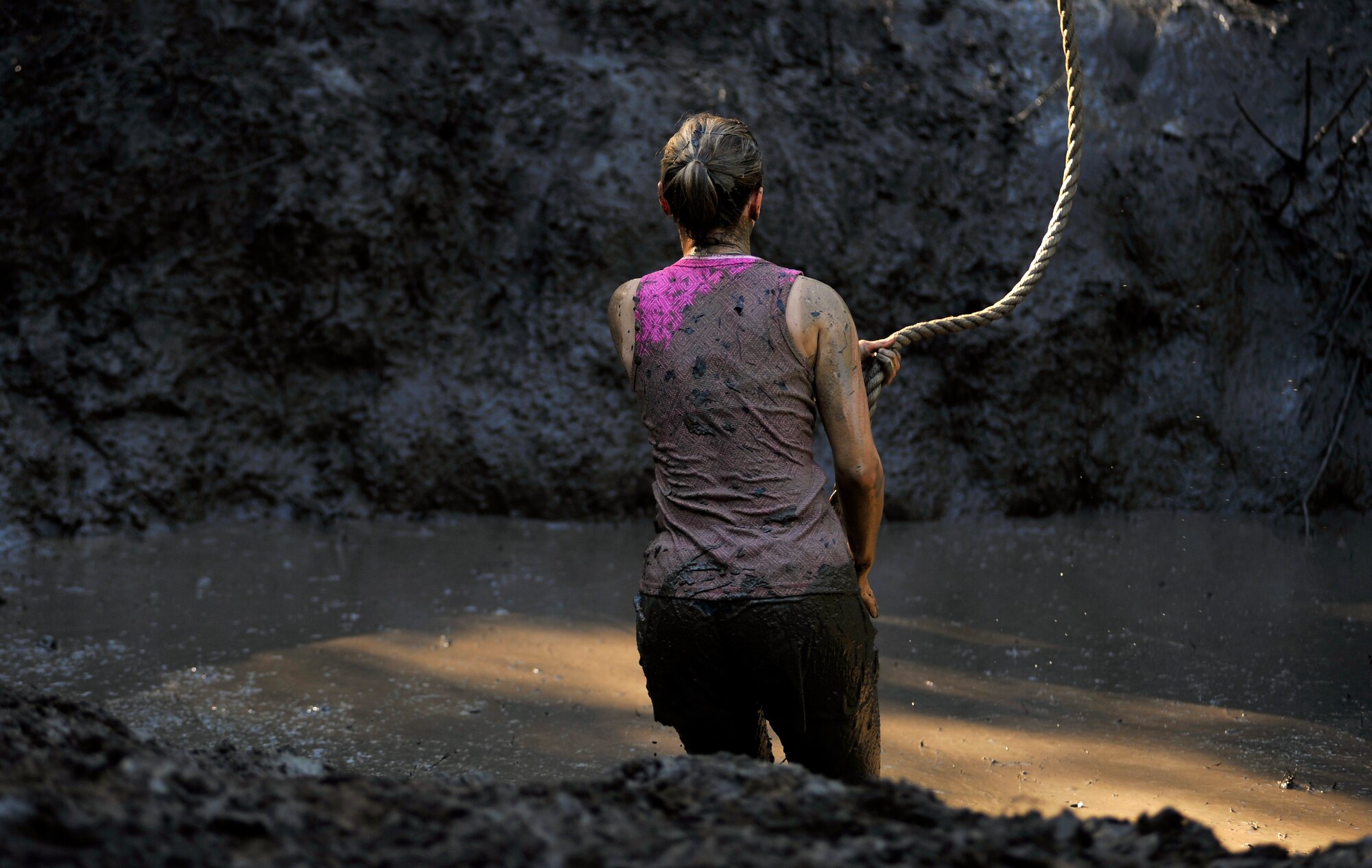 A participant of the U.S. Marine Corps Mud Run looks across a soupy mud pit as she prepares to swing across it to in order to keep her team in the race, Oct. 15, 2011, Columbia, S.C. Participants competed in four person teams in different categories: male, female, co-ed, homeland heroes, military, corporate and JROTC. (U.S. Air Force photo by Senior Airman Kenny Holston/Released)


