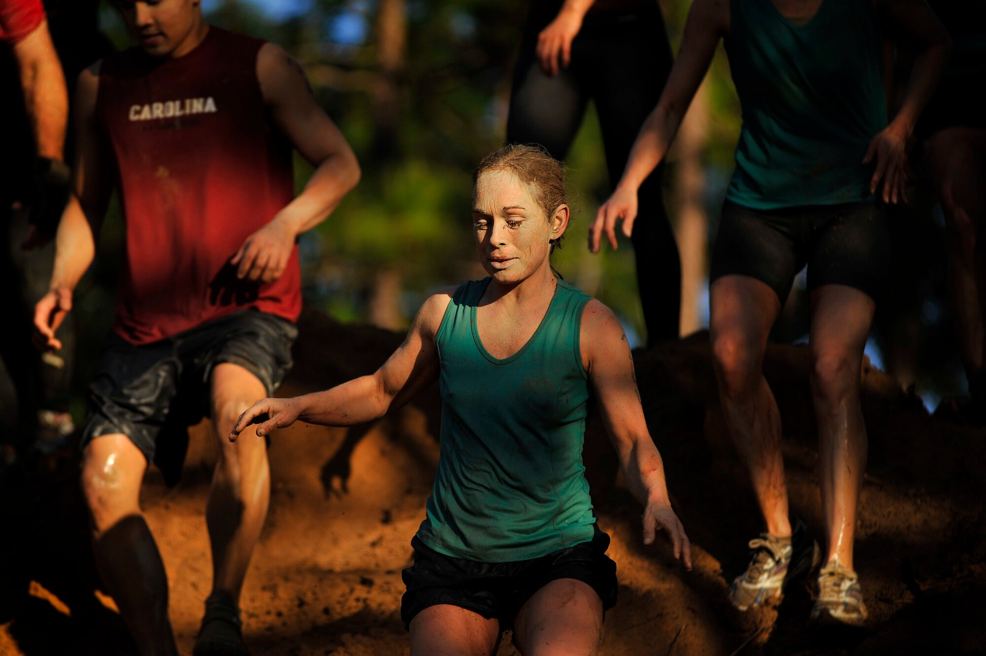 Participants at the U.S. Marine Corps Mud Run quickly make their way down a steep muddy hill, just one of the many obstacles during the race, Oct. 15, 2011, Columbia, S.C. The USMC Mud Run is a 5.2-mile course with 36 obstacles that each team needs to maneuver, requiring team work and loads of determination. The 5.2-mile course is an all-terrain race conducted on trails to include mud holes, walls, trenches, and other challenging obstacles that require swimming, crawling, climbing and jumping. (U.S. Air Force photo by Senior Airman Kenny Holston/Released)


