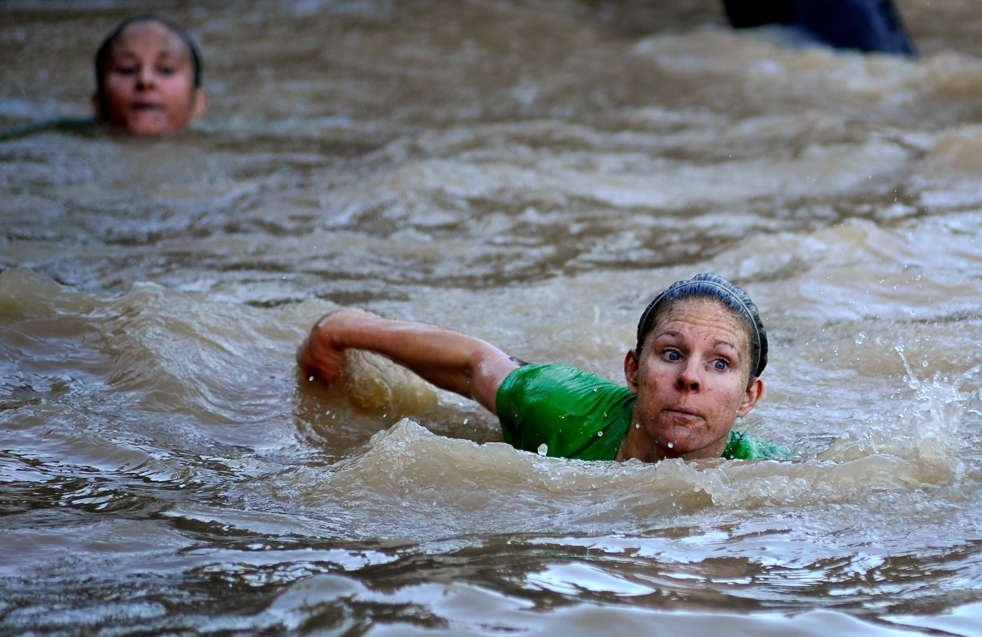 A participant at the U.S. Marine Corps Mud Run swims across a deep water hole during one of the many phases of the race, Oct. 15, 2011, Columbia, S.C. The USMC Mud Run is a 5.2-mile course with 36 obstacles that each team needs to maneuver, requiring team work and loads of determination. The 5.2-mile course is an all-terrain race conducted on trails to include mud holes, walls, trenches, and other challenging obstacles that require swimming, crawling, climbing and jumping. (U.S. Air Force photo by Senior Airman Kenny Holston/Released)


