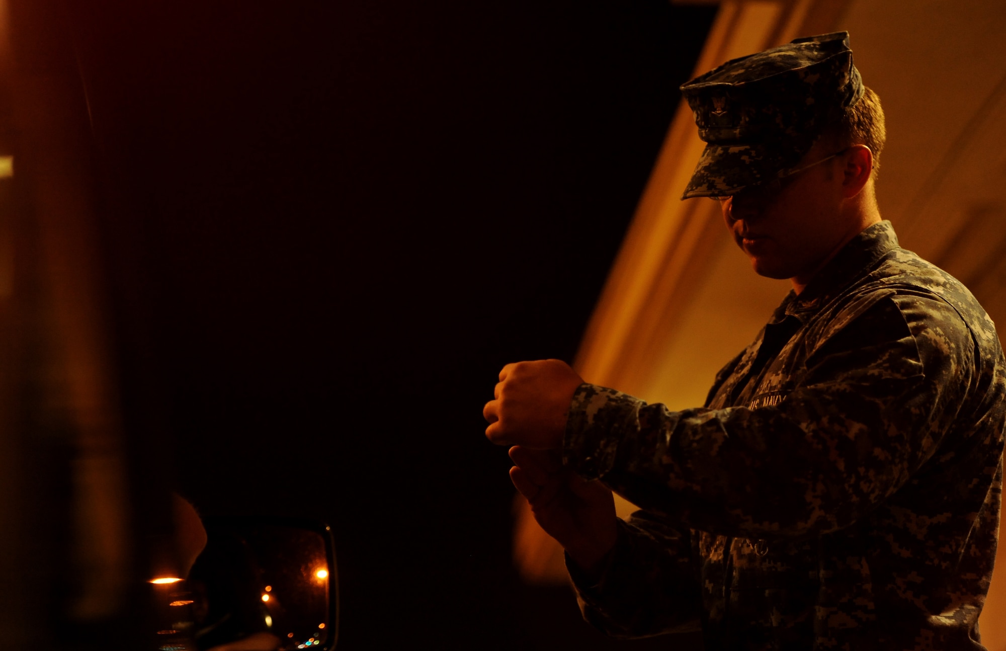 U.S. Navy Petty Officer 3rd Class Thomas Root, a master at arms attached to the 18th Security Forces Squadron, checks the identification card of a military dependent Oct. 26 on Kadena Air Base, Japan. Although Team Kadena is currently participating in local operational readiness exercise Beverly High 12-1, real-world mission requirements must still be met. (U.S. Air Force photo/Airman 1st Class Jarvie Wallace/released)
